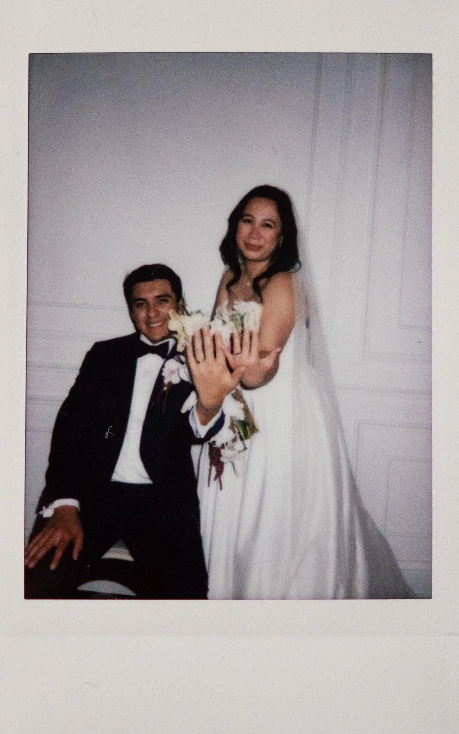 Moody polaroid wedding photographer a bride and groom hold their hands out to the camera to show off their wedding rings in the Parisian in Huntsville, Alabama. Moody Huntsville wedding photographer. Documentary Huntsville wedding photographer.