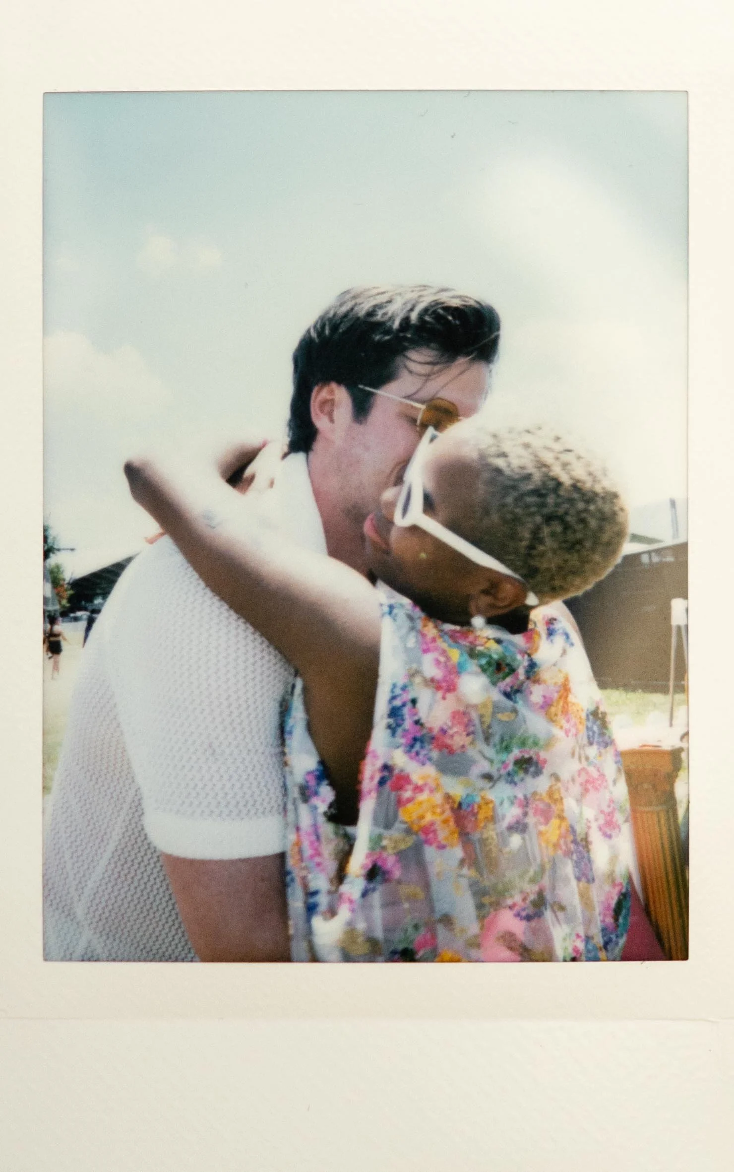 Instant film polaroid elopement photography a bride and groom embrace and kiss at Bonnaroo. Moody Nashville wedding photographer. Documentary wedding photographer.