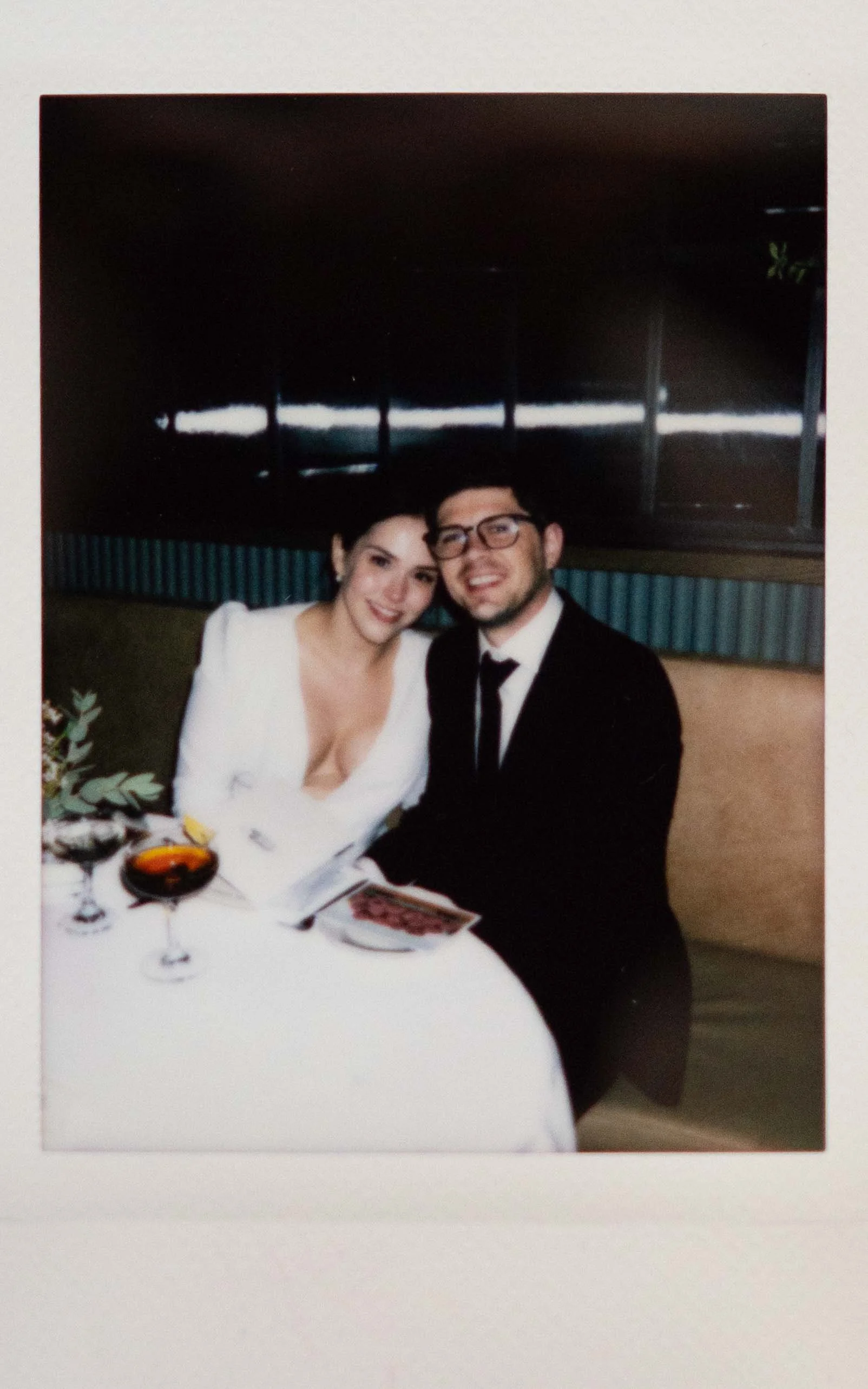 Instant film polaroid wedding photographer bride and groom smiling at the camera in Harvey House in Madison, Wisconsin. Moody Madison wedding photographer. Madison film wedding photographer.