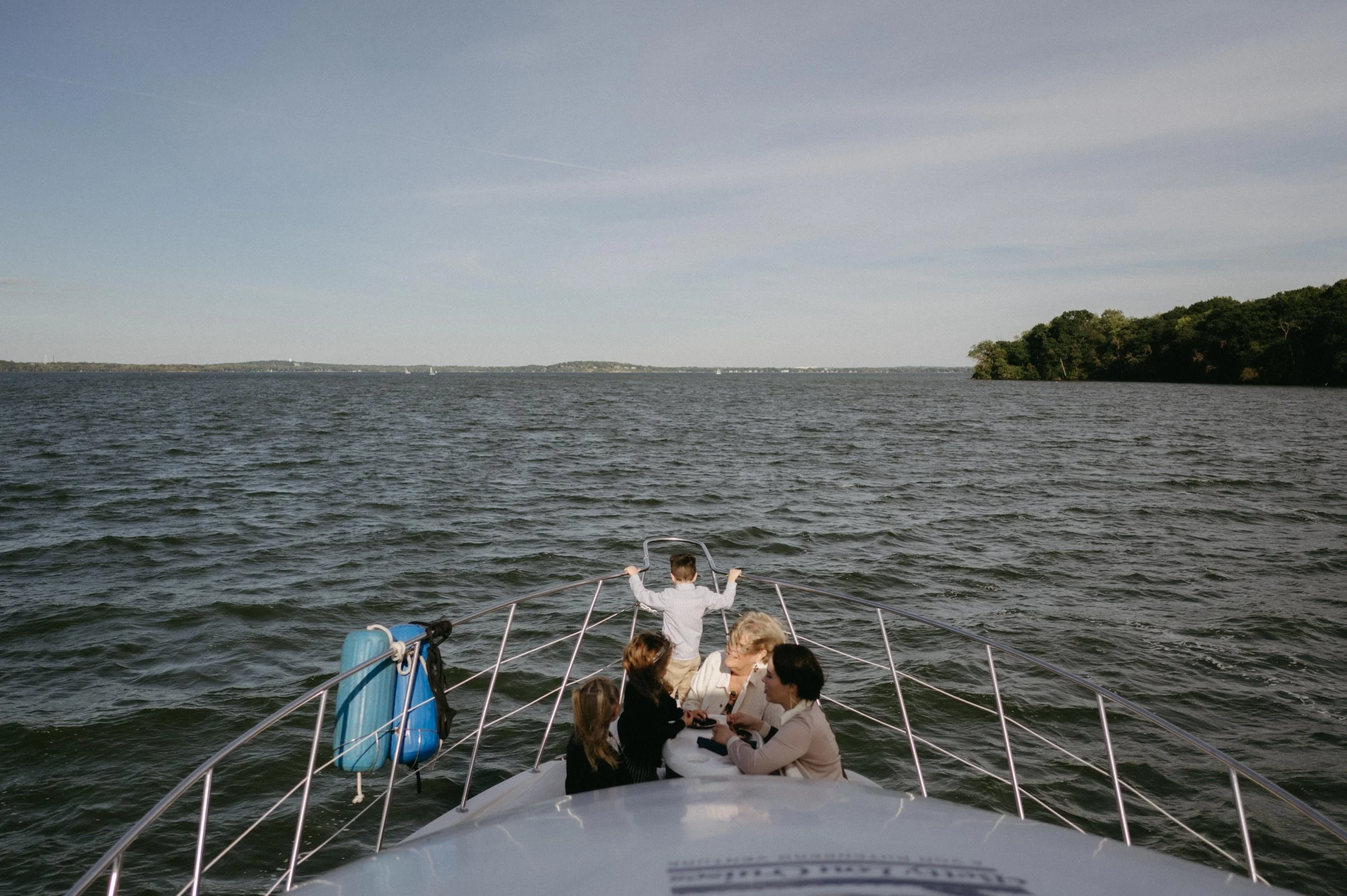 View of Lake Mendota during a wedding weekend welcome dinner cruise in Madison, Wisconsin. Moody Madison wedding photographer. Documentary wedding photographer.