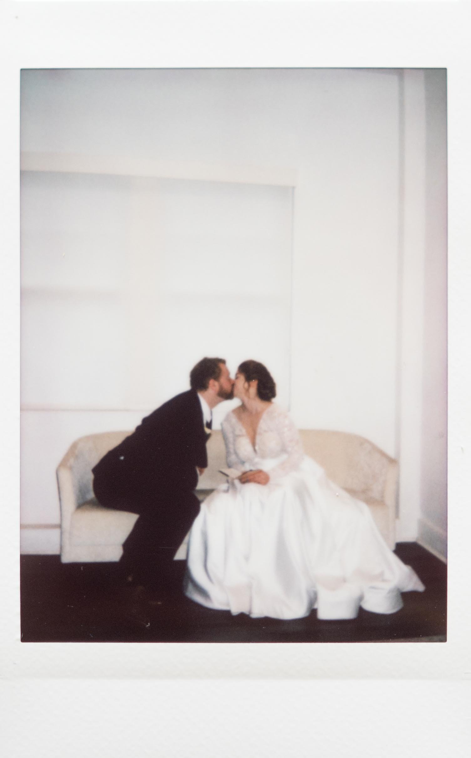 Instant film polaroid photography bride and groom kissing during a private vow reading at The Kent in Memphis, Tennessee. Moody Memphis wedding photographer. Memphis film wedding photographer.