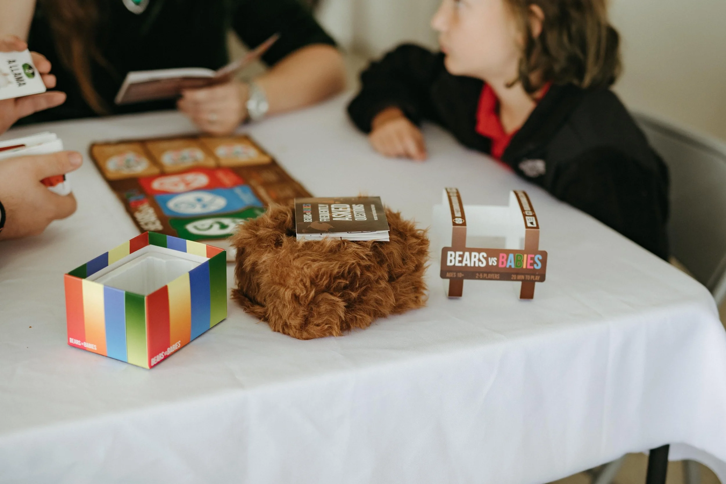 Moody Memphis wedding photographer wedding guests play a board game at a wedding reception. Documentary Memphis Wedding Photographer. Cinematic Memphis wedding photographer.
