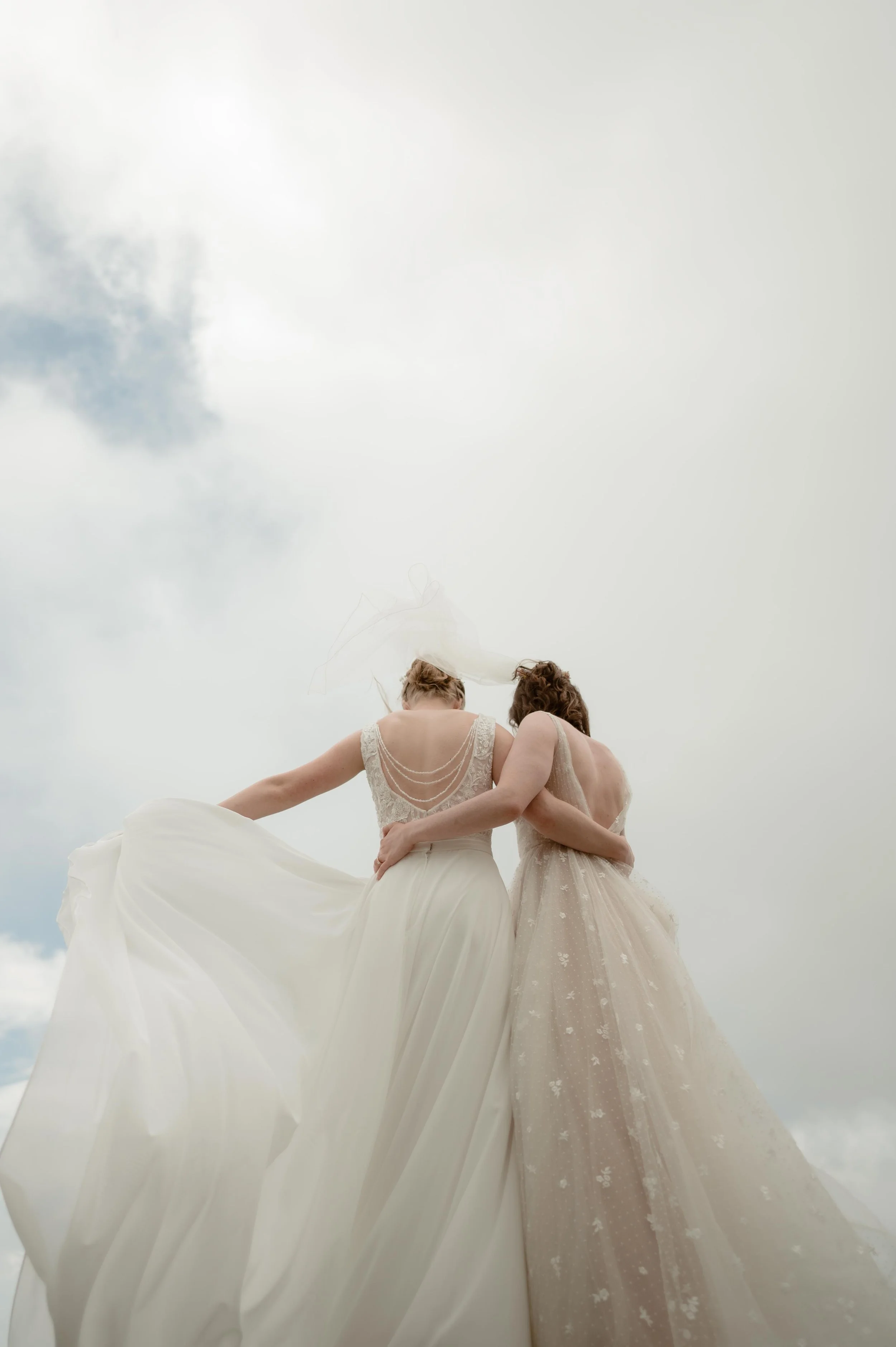 Cinematic North Carolina wedding photography two brides pose overlooking the Appalachian mountains in Nantahala, North Carolina. Cinematic Memphis wedding photographer. Moody Memphis wedding photographer. Moody North Carolina wedding photographer.