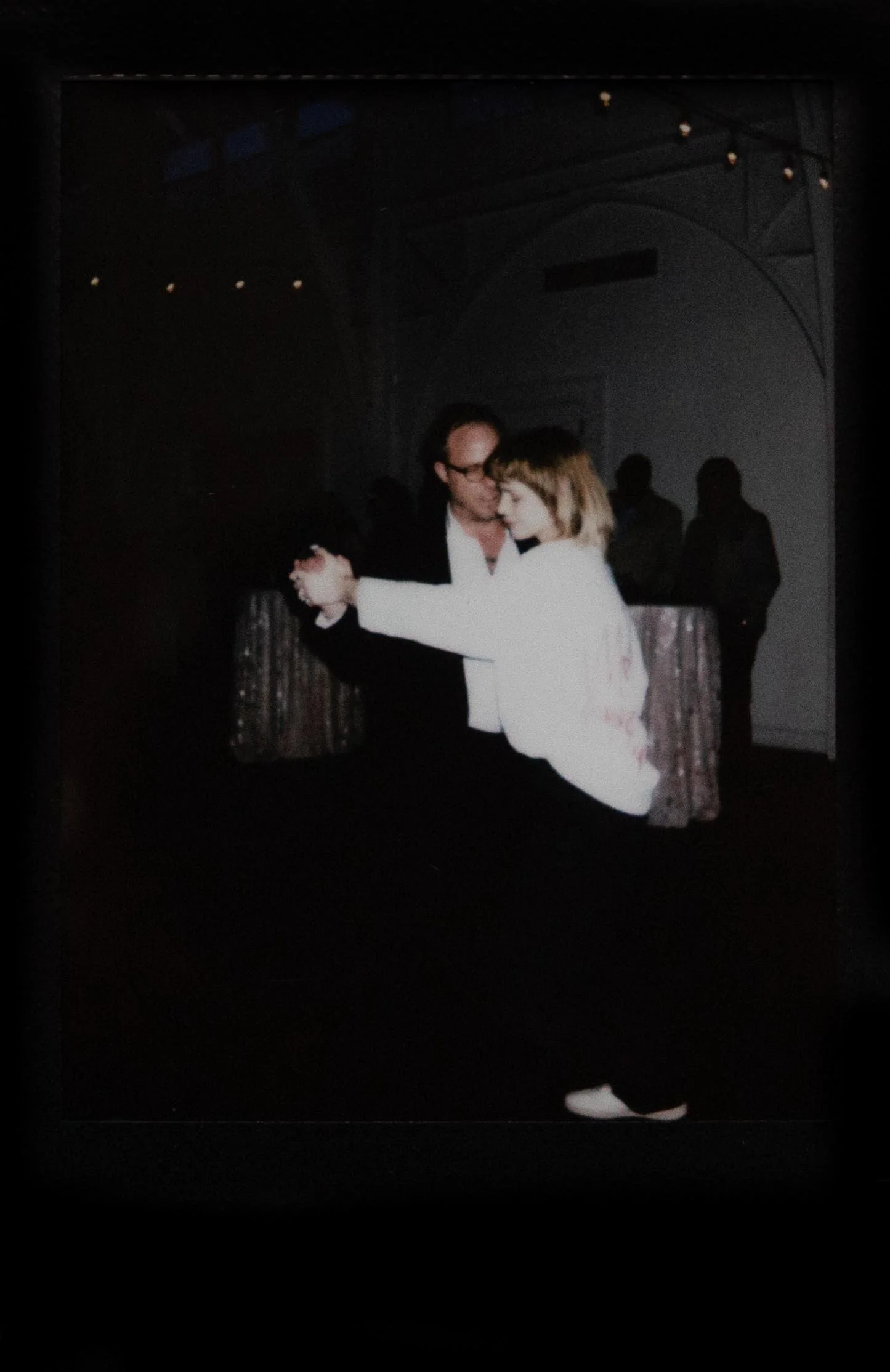 Instant film polaroid wedding photography a bride and groom dance their first dance at The Atrium at Overton Square in Memphis, Tennessee. Moody Memphis wedding photographer. Documentary Memphis wedding photographer.