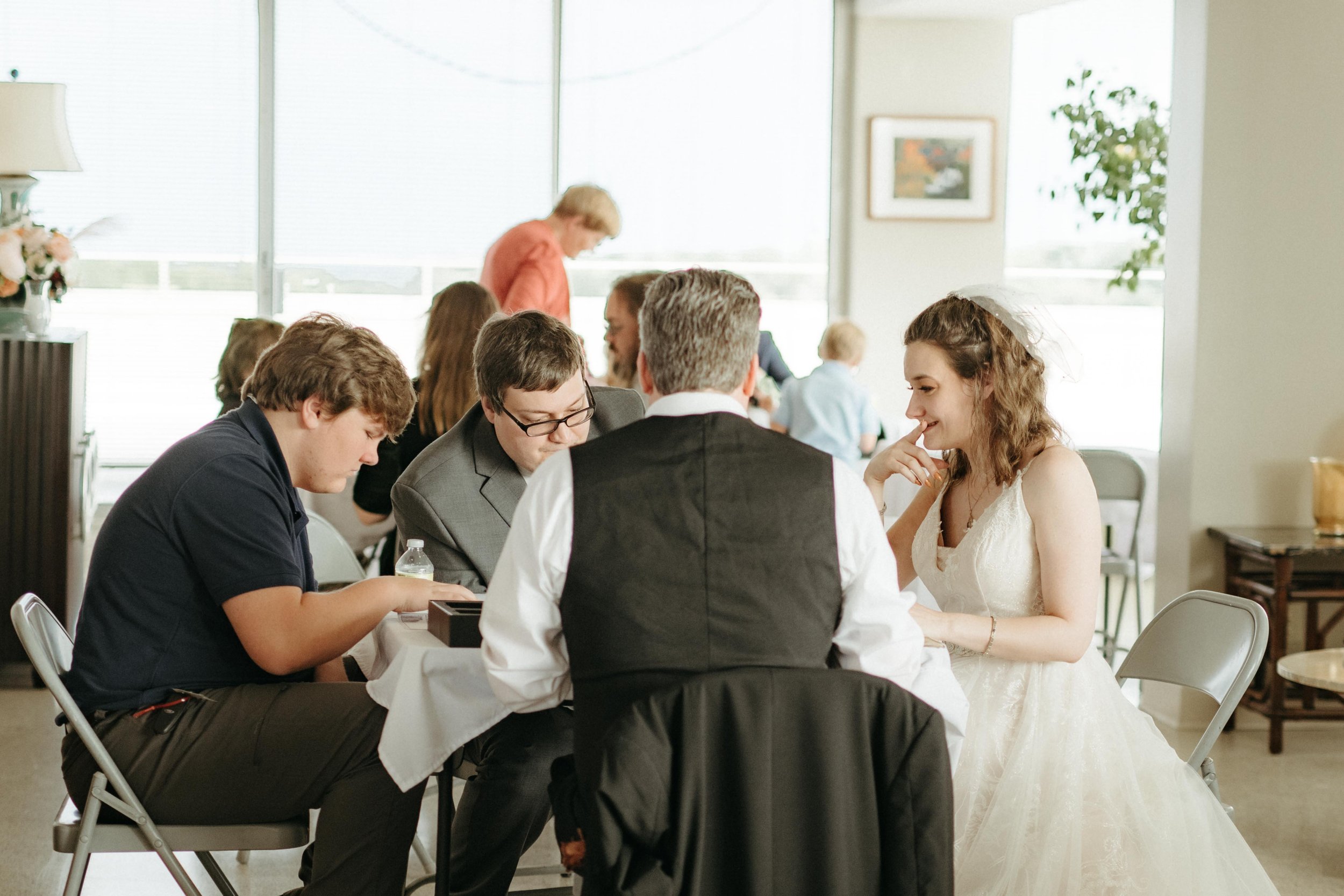 Moody Memphis wedding photographer a bride and groom play a board game at their wedding reception. Documentary Memphis Wedding Photographer. Cinematic Memphis wedding photographer.