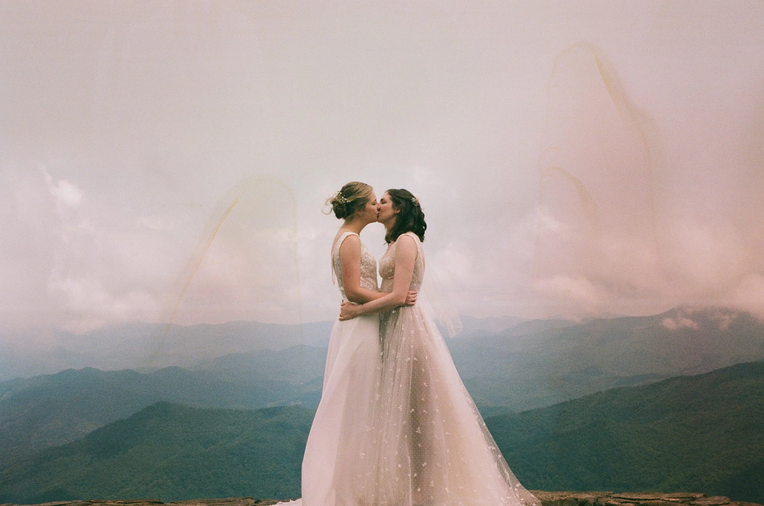 Film wedding photographer two brides kiss on a mountaintop in Nantahala, North Carolina on 35 mm film. Memphis film wedding photographer. North Carolina film wedding photographer. Memphis Documentary wedding photographer.