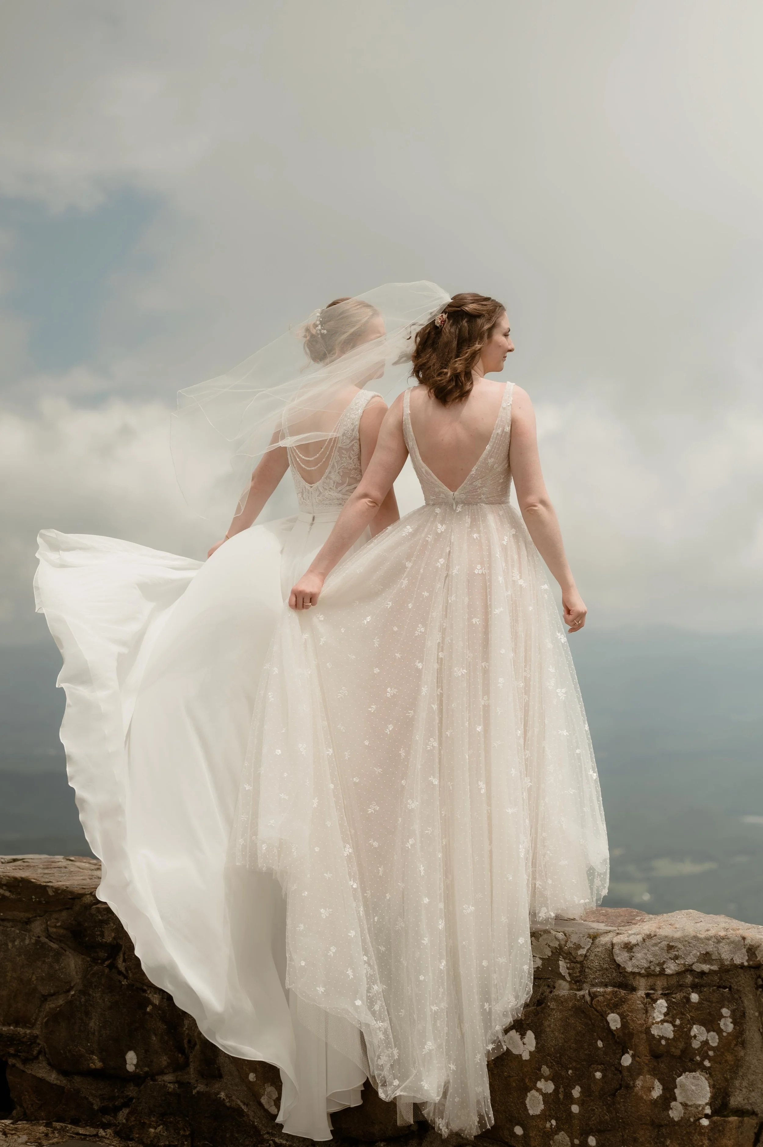Cinematic North Carolina wedding photography two brides pose overlooking the Appalachian mountains in Nantahala, North Carolina. Cinematic Memphis wedding photographer. Moody Memphis wedding photographer. Moody North Carolina wedding photographer.