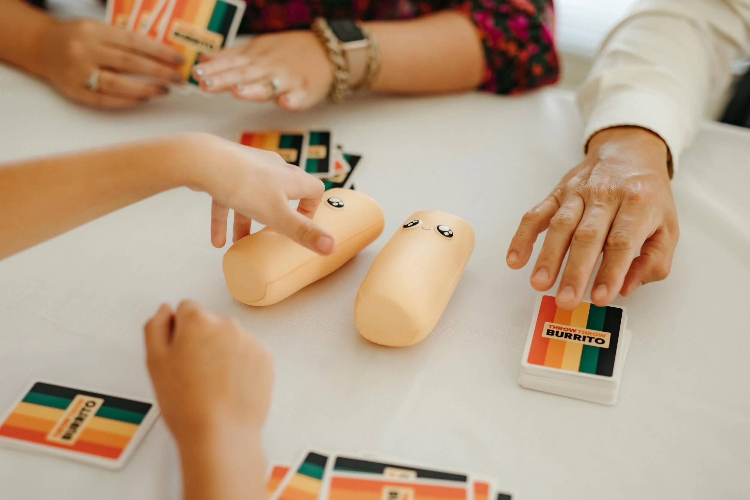 Moody Memphis wedding photographer wedding guests play a board game at a wedding reception. Documentary Memphis Wedding Photographer. Cinematic Memphis wedding photographer.
