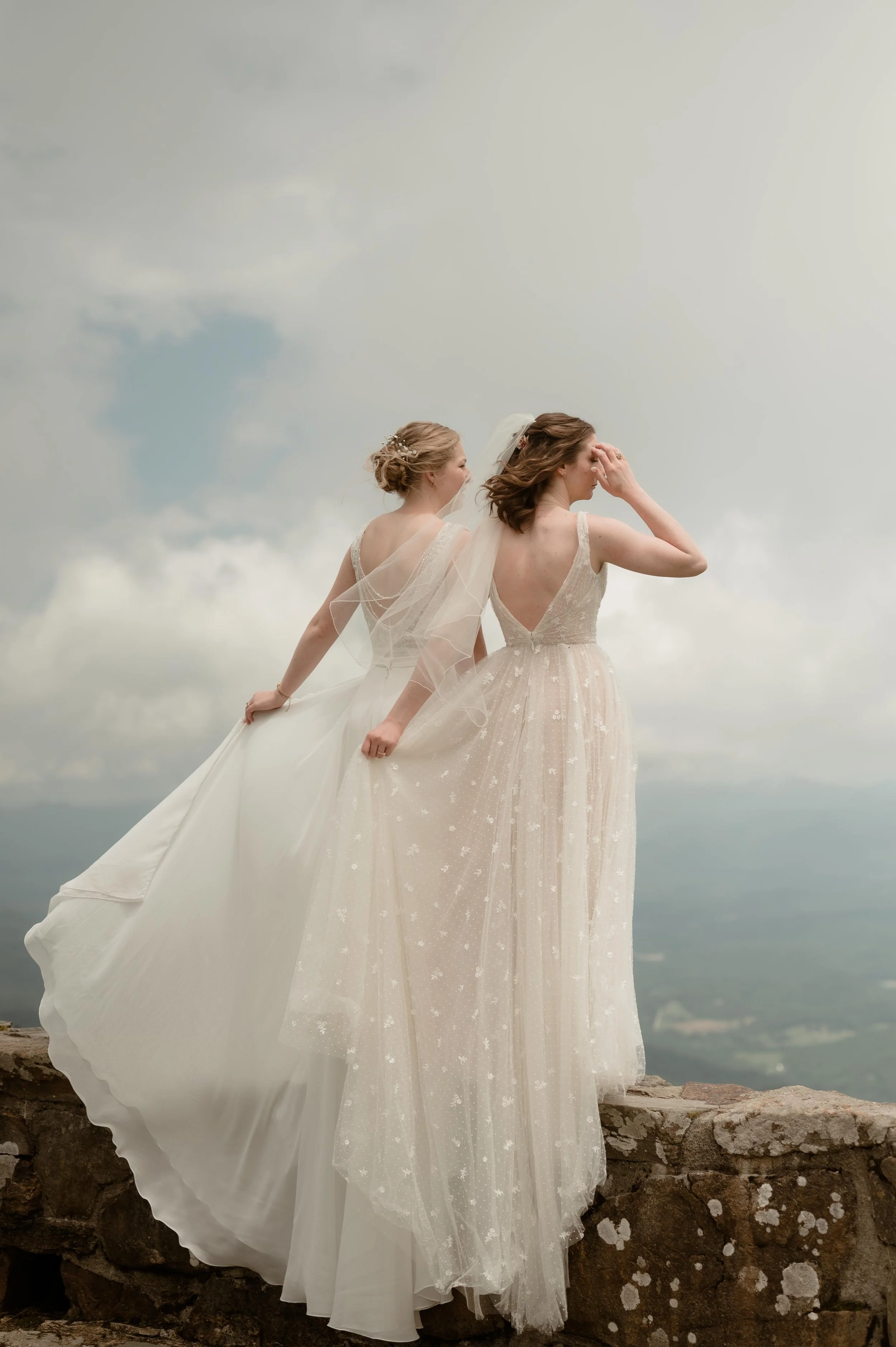 Cinematic North Carolina wedding photography two brides pose overlooking the Appalachian mountains in Nantahala, North Carolina. Cinematic Memphis wedding photographer. Moody Memphis wedding photographer. Moody North Carolina wedding photographer.