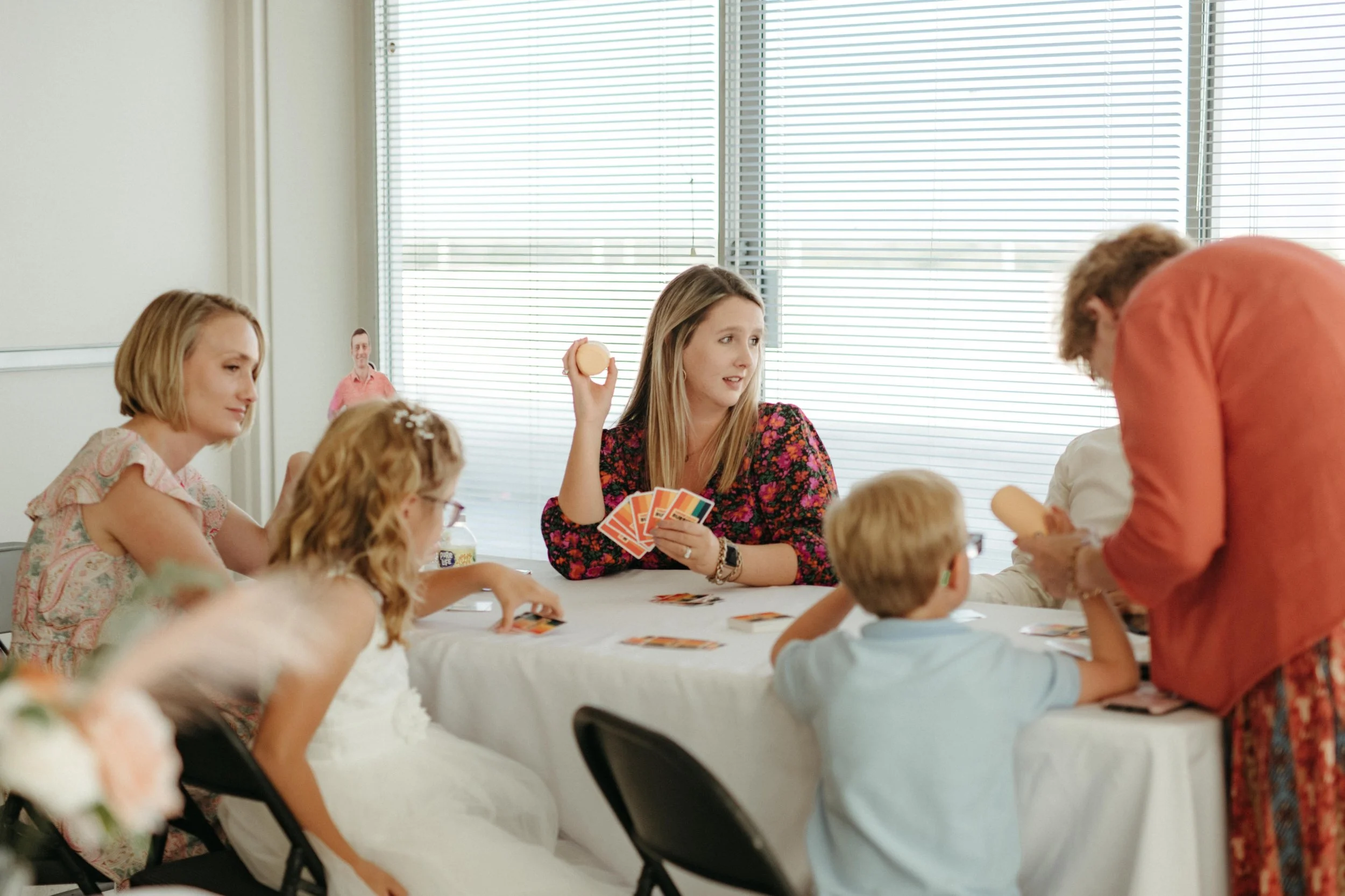 Moody Memphis wedding photographer wedding guests play a board game at a wedding reception. Documentary Memphis Wedding Photographer. Cinematic Memphis wedding photographer.