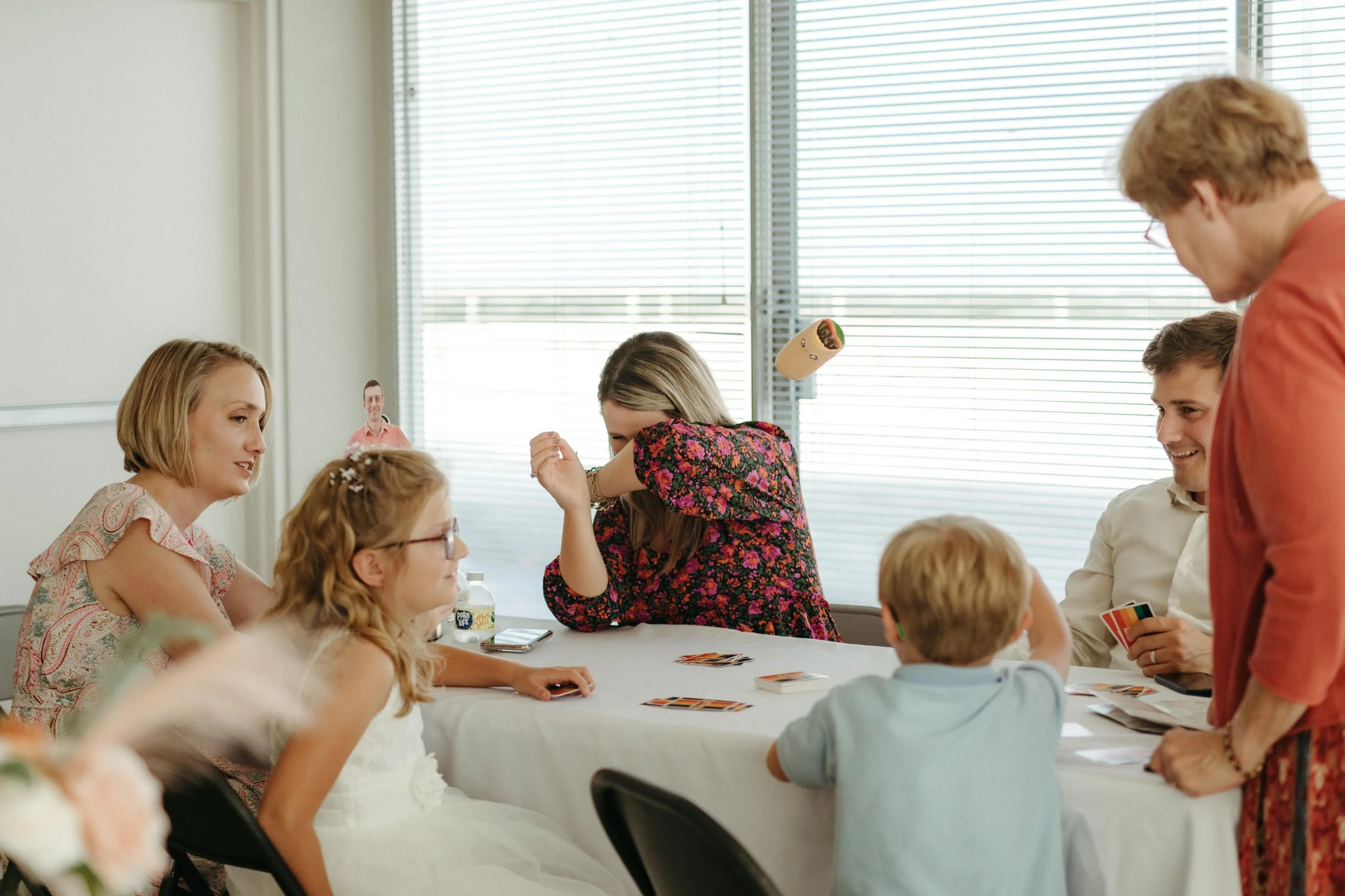 Moody Memphis wedding photographer wedding guests play a board game at a wedding reception. Documentary Memphis Wedding Photographer. Cinematic Memphis wedding photographer.