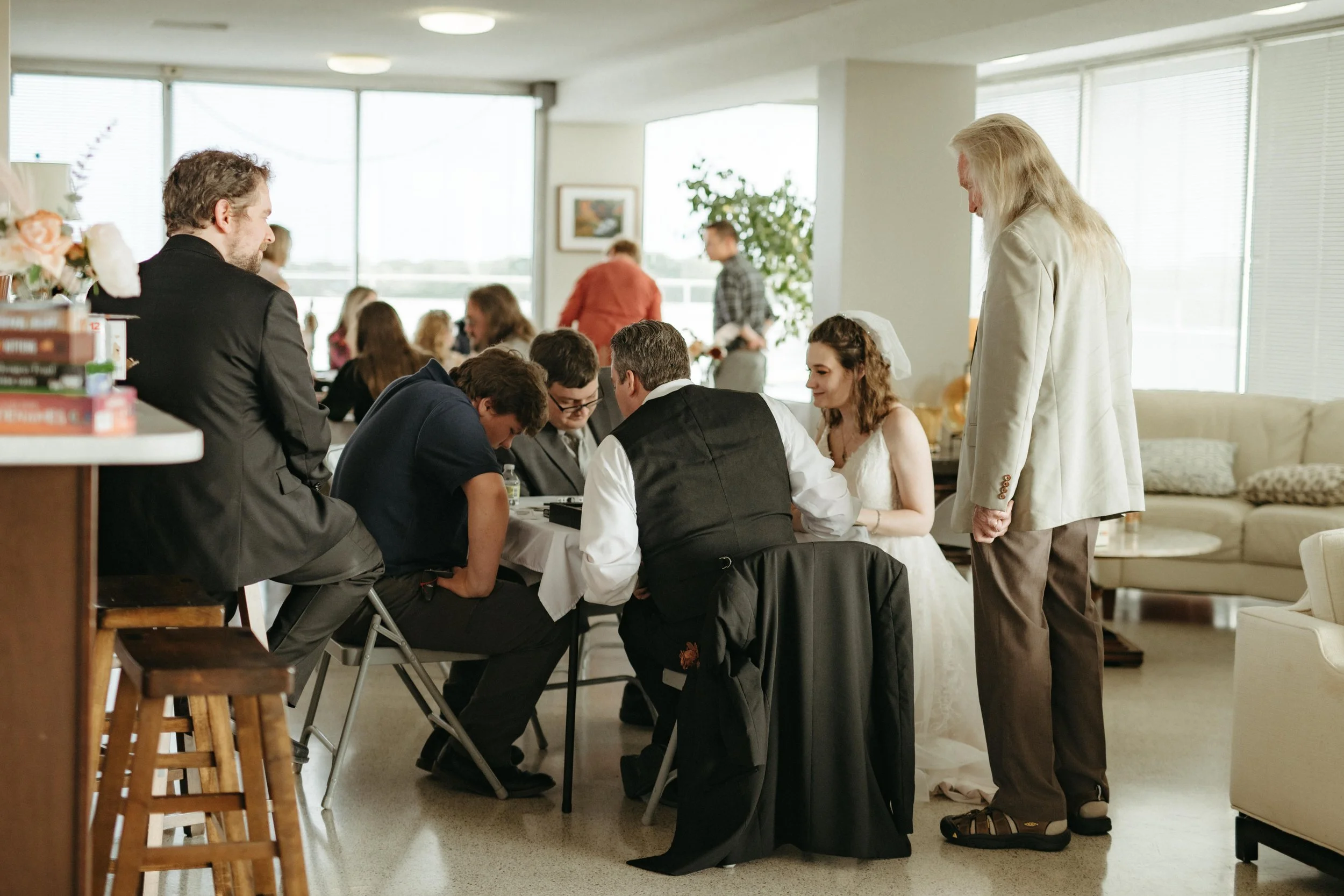 Moody Memphis wedding photographer a bride and groom play a board game at their wedding reception. Documentary Memphis Wedding Photographer. Cinematic Memphis wedding photographer.