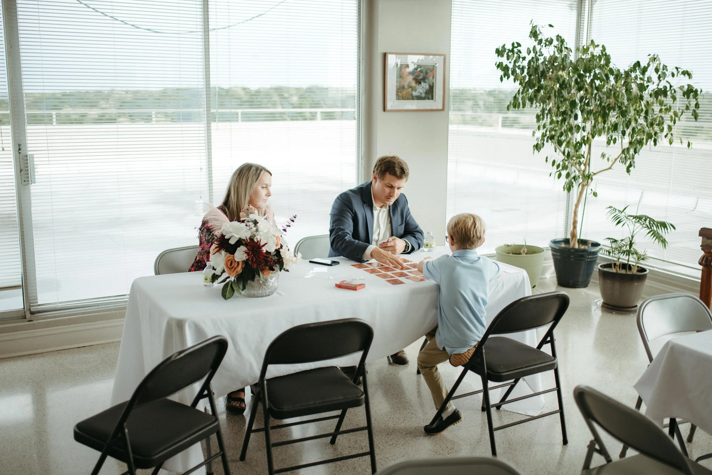Moody Memphis wedding photographer wedding guests play a board game at a wedding reception. Documentary Memphis Wedding Photographer. Cinematic Memphis wedding photographer.