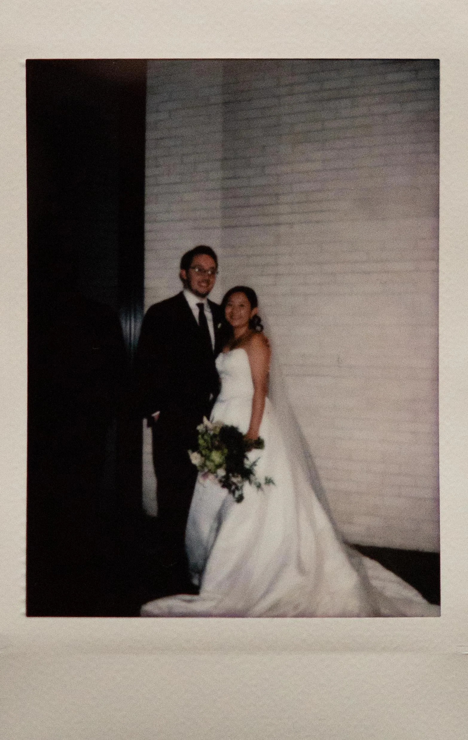 Instant film polaroid wedding photography a bride and groom pose smiling at the camera in the Church of the River in Memphis, Tennessee. Moody Memphis wedding photographer. Memphis film wedding photographer.