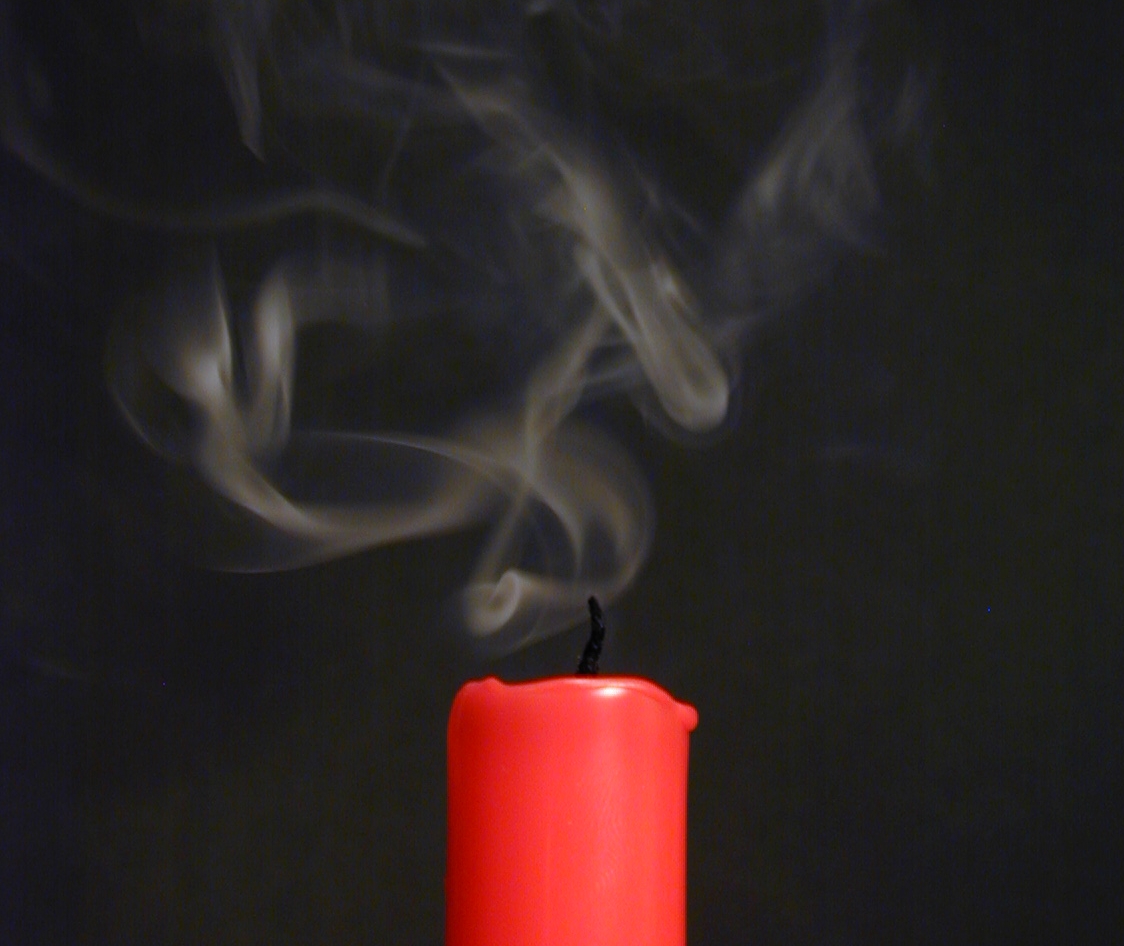The smelly stream of gas and microscopic smoke particles which continues to flow up from the wick for just a few seconds after the flame is blown out. Read Faraday's next paragraph carefully. This is one of the very best dinner-table candle experiments!