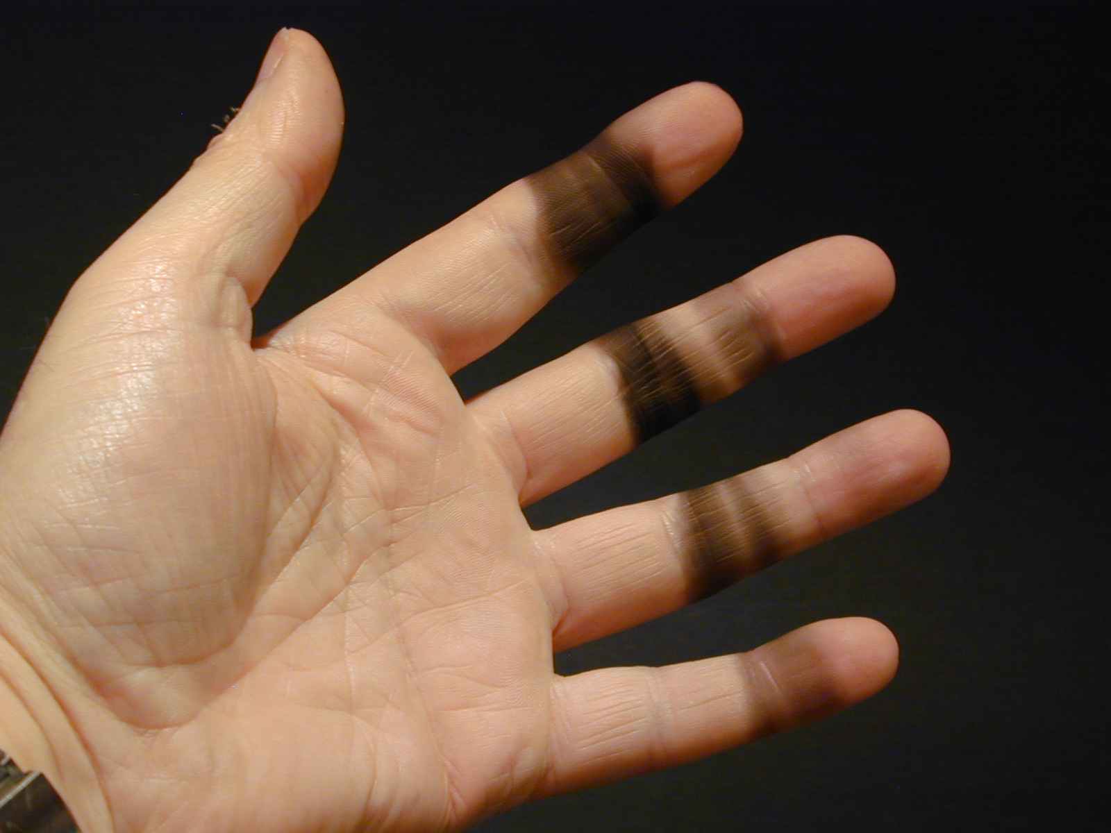 The rest of the unburned particles form this greasy black soot on your fingers. Most of it can be wiped off fairly easily with a paper napkin. I had repeated the experiment several times before taking this photograph.