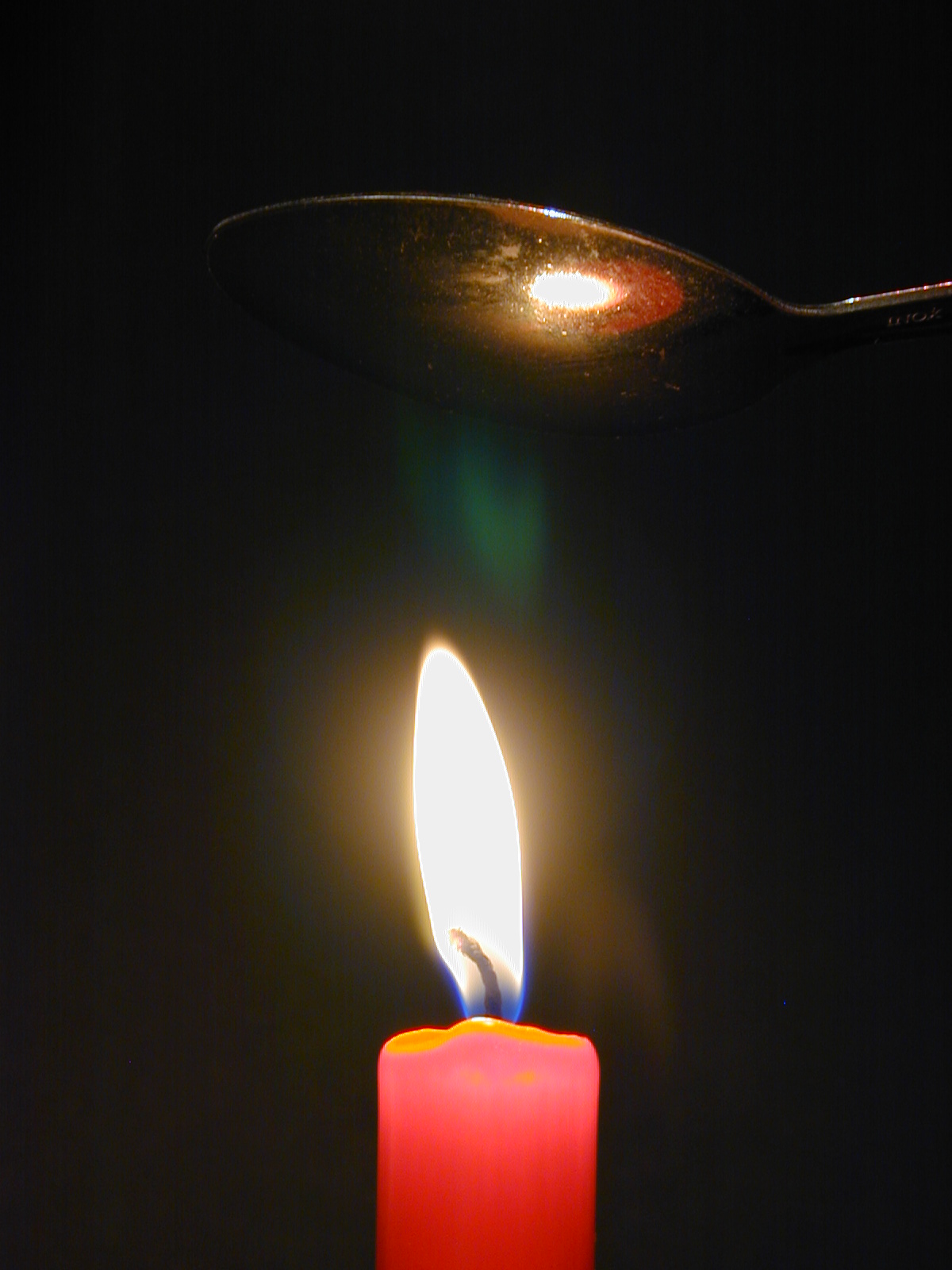 This works best with the newest. shiniest spoon you can find. Make sure the spoon is reasonably cool then hold it several inches above the flame for just a couple of seconds, while watching it closely. If the metal is shiny enough, you see it briefly mist over, just as if you had breathed on it. The effect is brief, because the flame quickly warms the metal. Allow the spoon to cool before repeating the experiment, or use another spoon.
