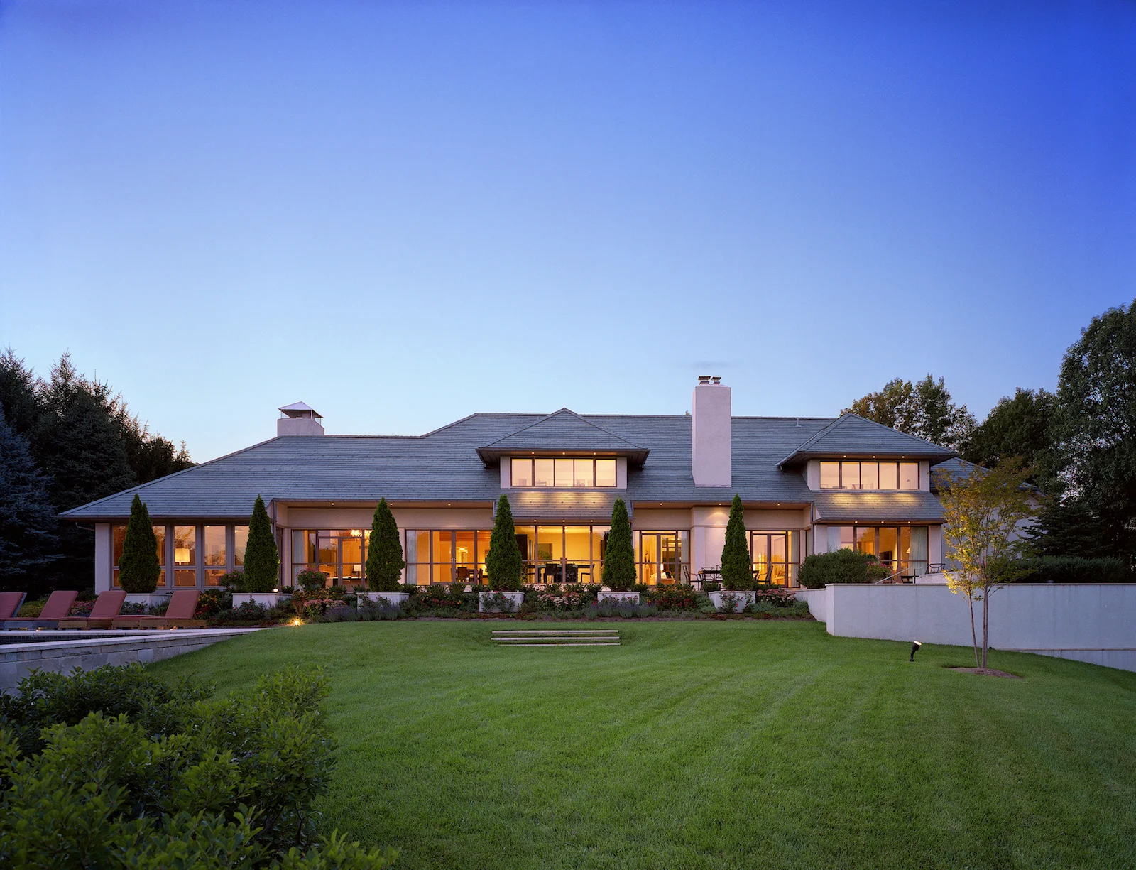 expansive lawn leading to large modern home.jpg