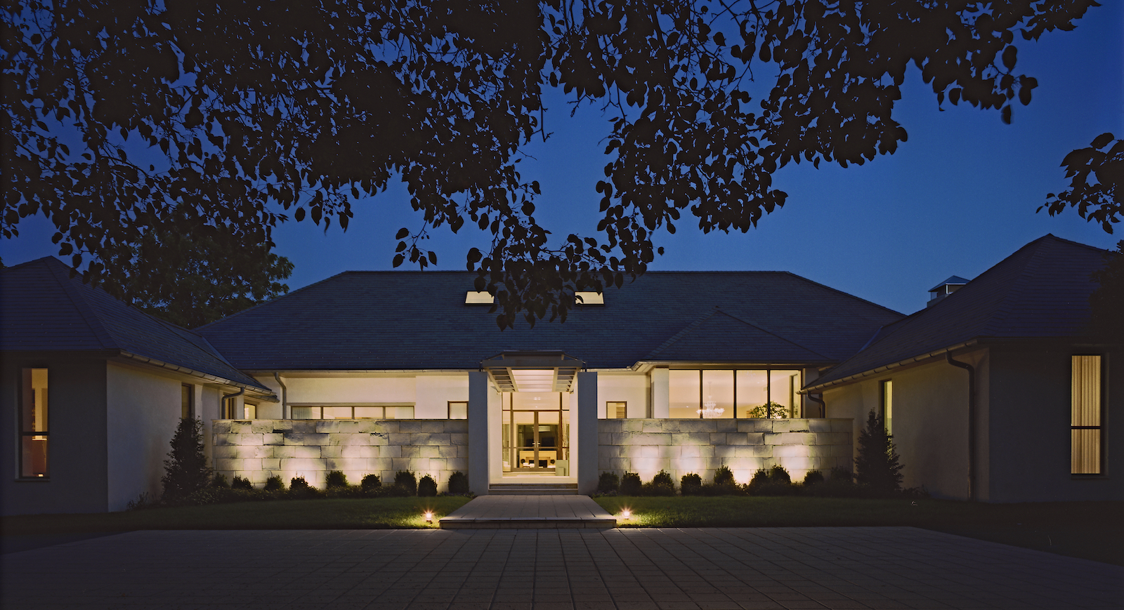 modern home in the evening with pot lights.jpg