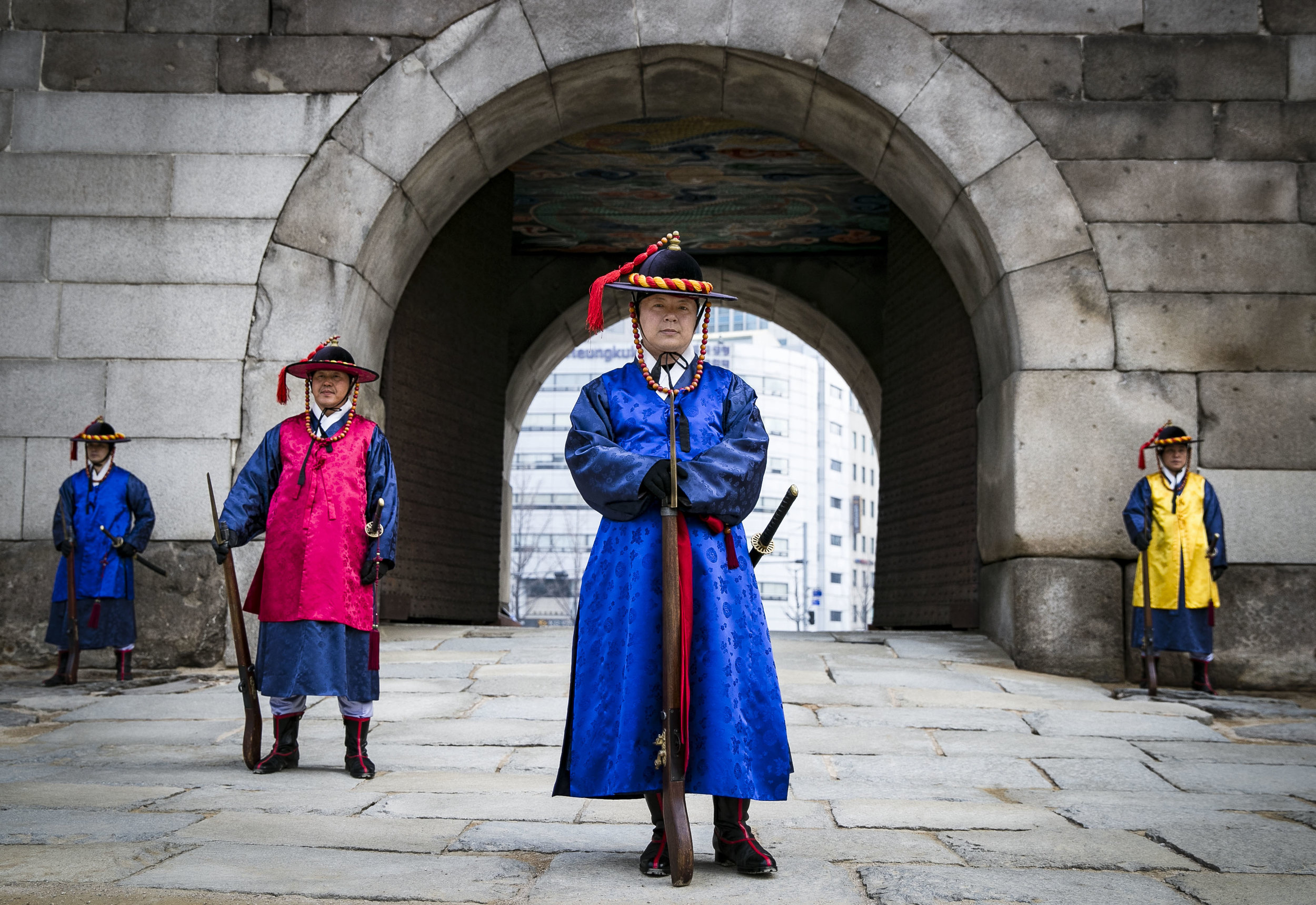  The Namdaemun market is the largest and oldest in the city of Seoul, South Korea guarded by traditional Korean guards behind the “Great South Gate.” The market has traditional food, clothing, a fish market, and accessories. Between the cars driving 