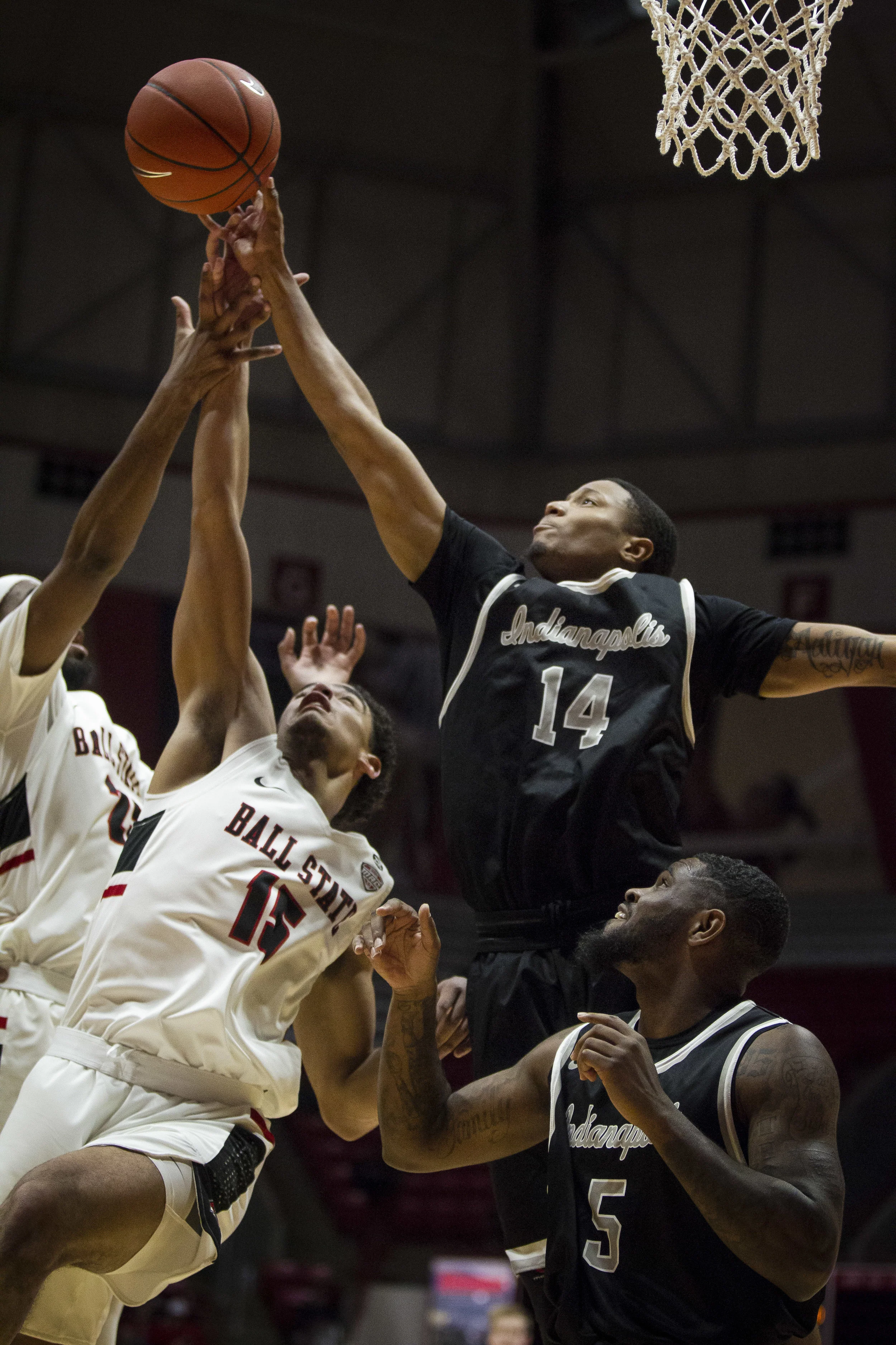 No. 15 forward Zach Gunn reaches for a rebound against UIndy No. 14 guard CJ Hardaway, Nov. 1, at Worthen Arena, Muncie, Ind. Photos for Ball State Creative Services
