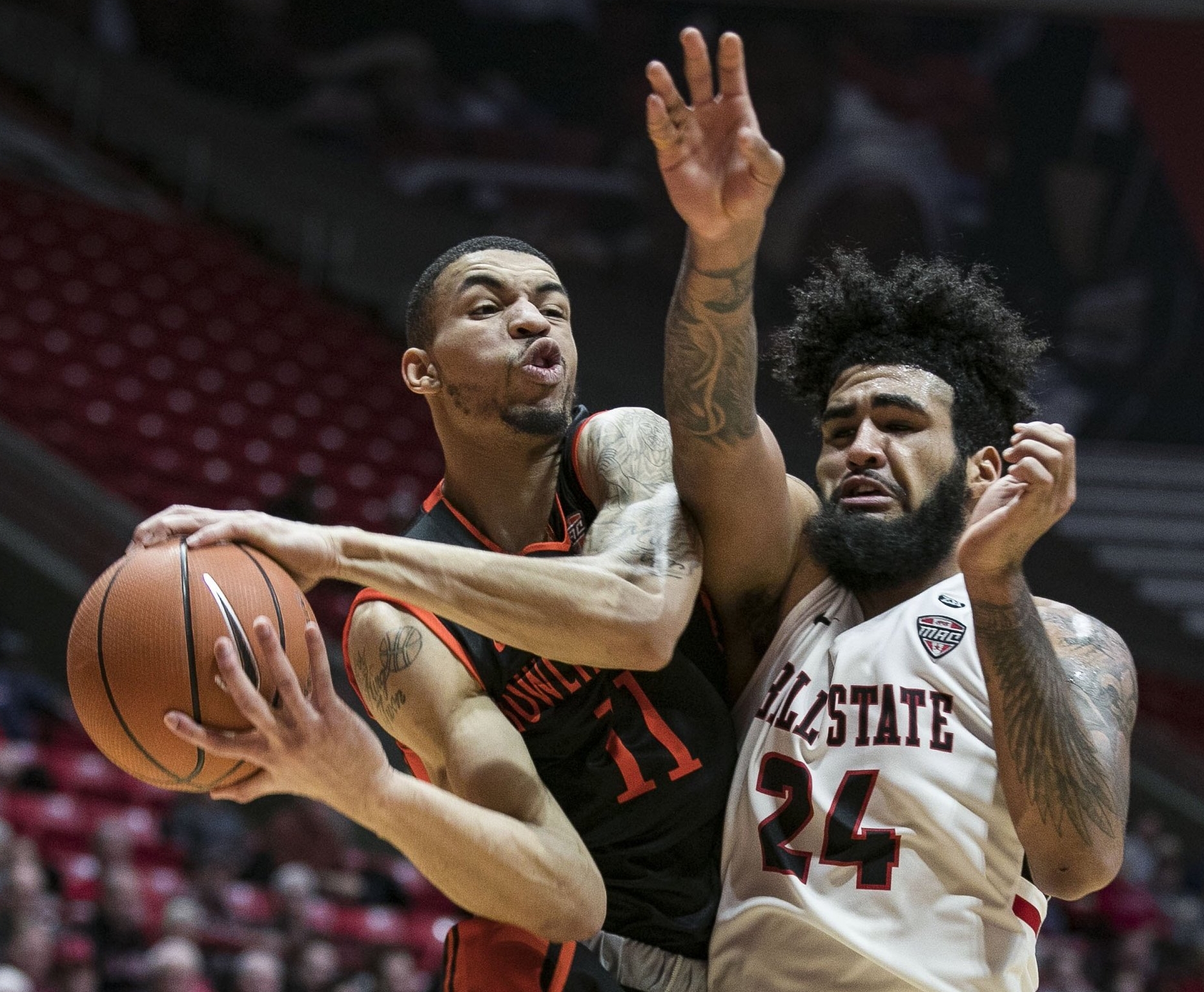  Ball State junior guard Trey Moses reaches for a rebound against a Bowling Green forward , Feb. 6 at John E. Worthen Arena, Muncie, Ind. Ball State defeated Bowling Green in a last second three point buzzer, 59-56.  Photos for Ball State Photo Servi