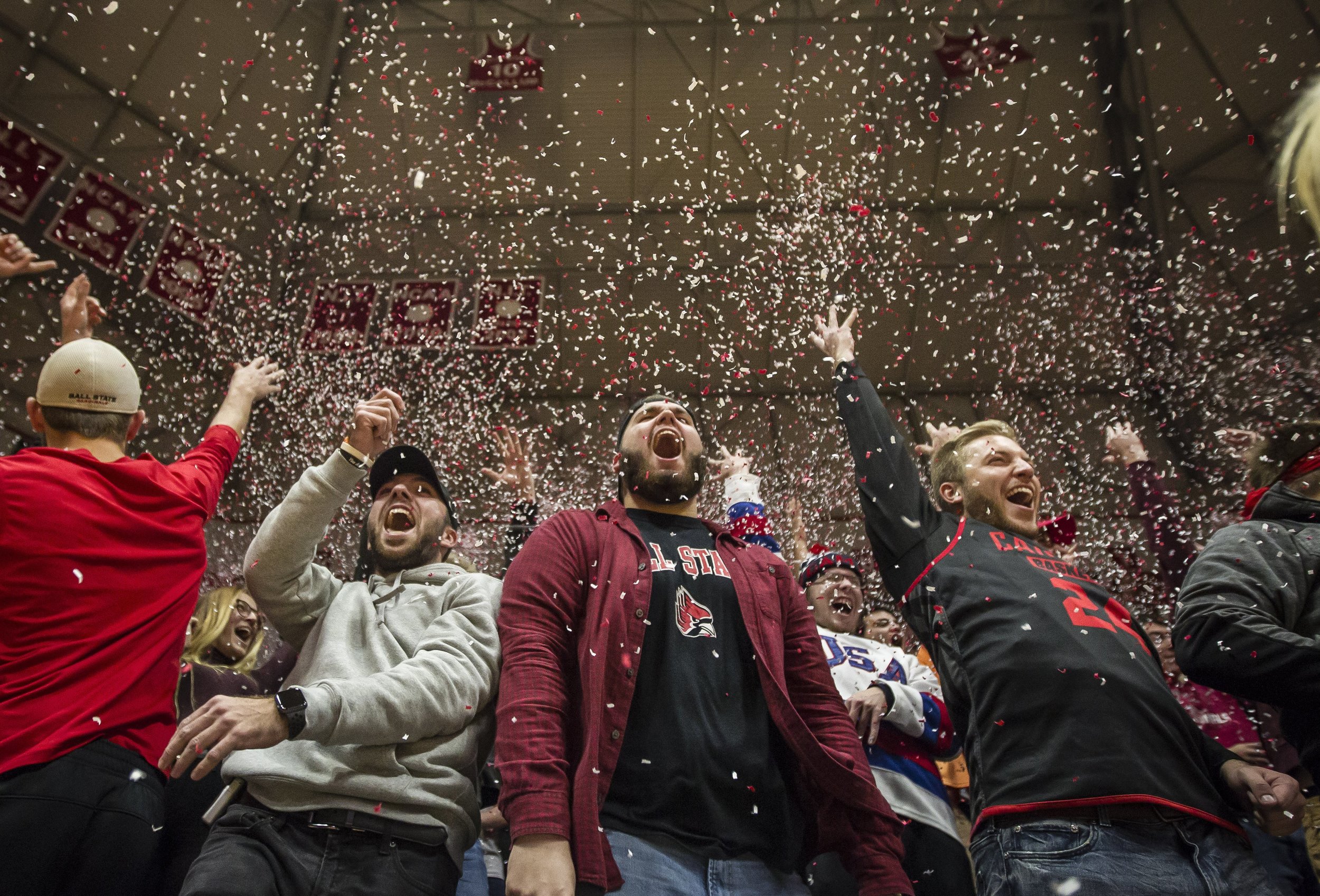  Ball State students Jacob Huesing, Nick Smith and Bobby Clone throw confetti after Ball State scored their first point in the home opener against Indiana State University, Nov. 6, at Worthen Arena.  Photos for Ball State Creative Services  