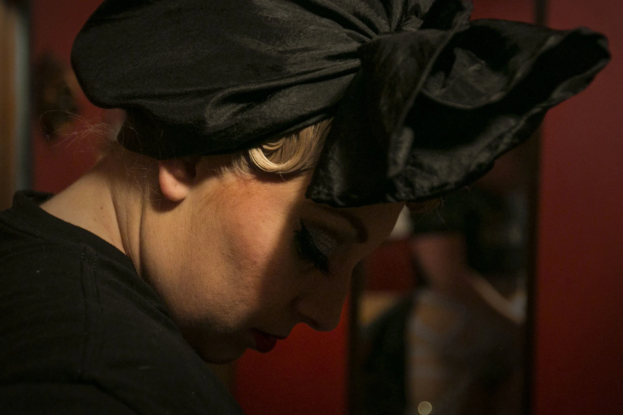  Stephanie Hutchison looks at her costume while standing in the dressing room of Mark III Tap Room, Feb. 27, in Muncie, IN, as she prepares for a burlesque show apart of the Funcie Femme Burlesque Troop. Stephanie’s impact on the community started wi