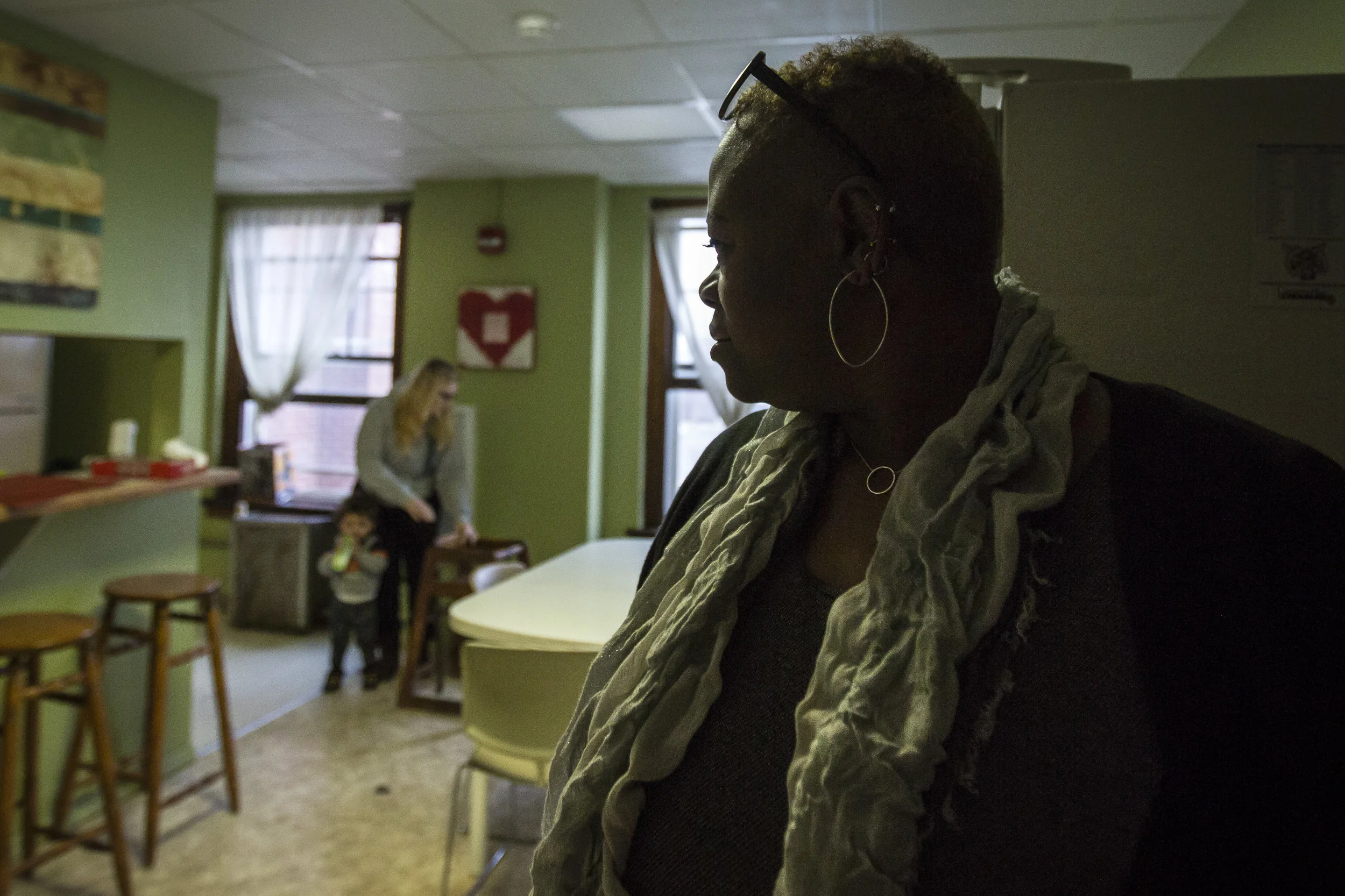   WaTasha Barnes Griffin stands in the door way of the second floor kitchen and asks how the young woman and her child are doing, Jan. 16, at the YWCA on East Charles Street, Muncie, IN. Since she was a young girl, WaTasha recalls always being helpin