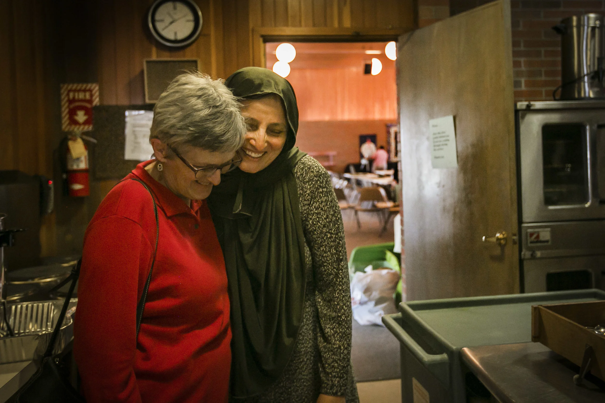  Leaning in for her famous hugs, Bibi Bahrami (right) embraces a board member of the non for profit AWAKEN on Saturday, April 6, at Unitarian Universalist Church of Muncie. The doors remained open to the church that afternoon as people carried chairs