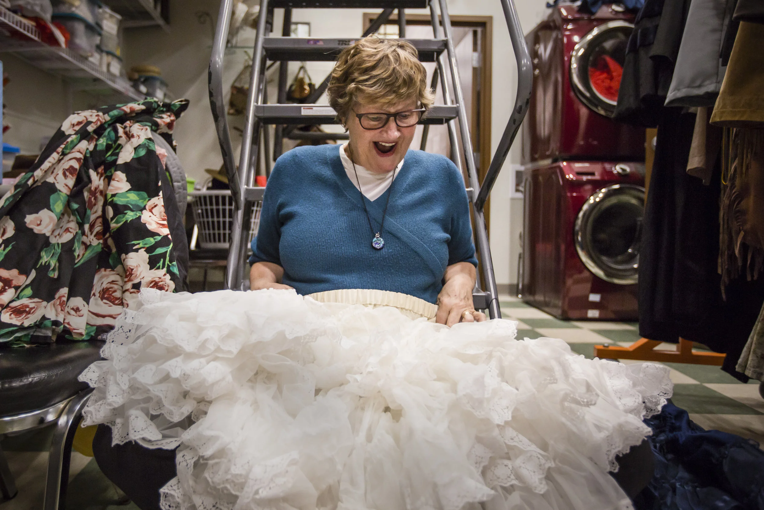  Nancy Carlson holds up a skirt in excitement after digging through a box of costumes and props, Feb. 24, at Muncie Civic Theatre, in downtown Muncie, IN. Nancy will spend some time at Civic organizing and fixing costumes  and the next hour somewhere