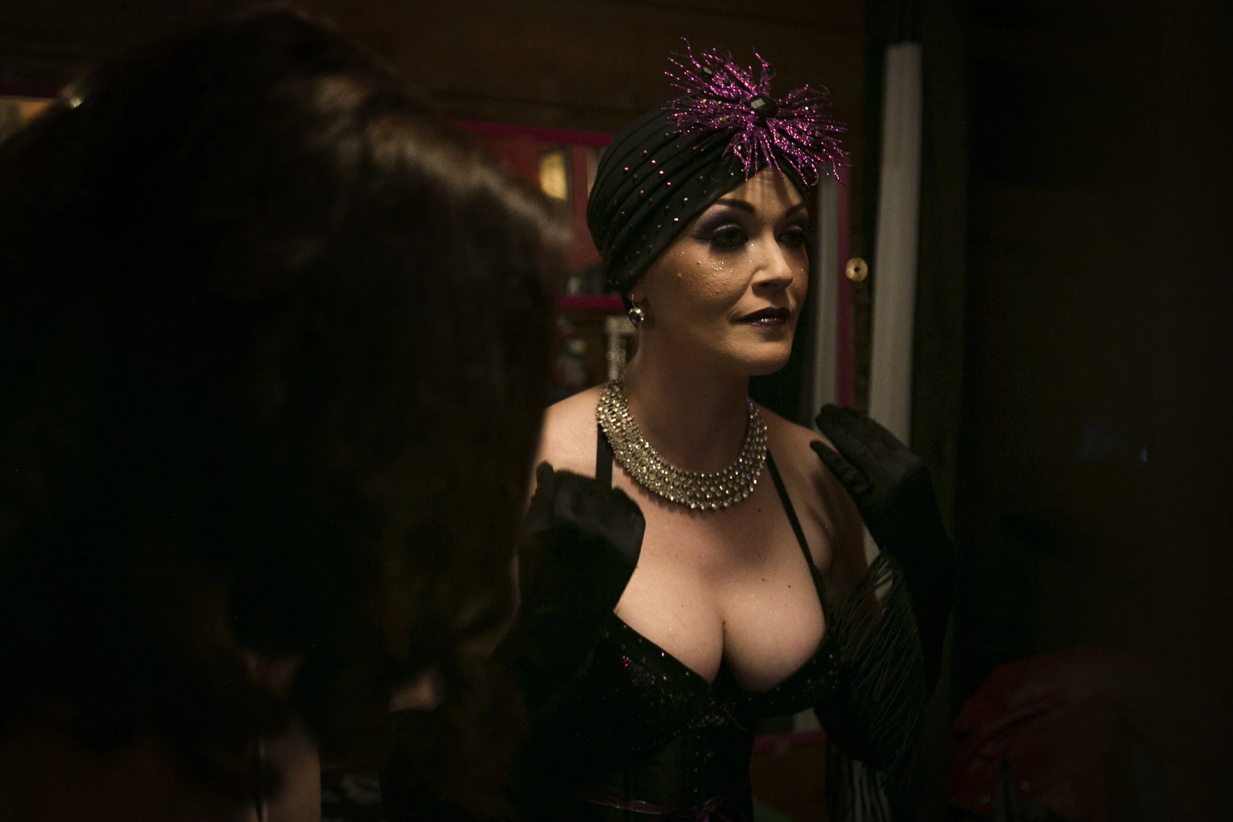  Fixing the final pieces to her costume, Jamie Prang(Lady J) also known as Mrs. Mayhem, looks in the mirror before the start of the burlesque show, Feb. 27, at Mark's III, Muncie, IN. For ten years, Jamie has found ways to use her art of burlesque da