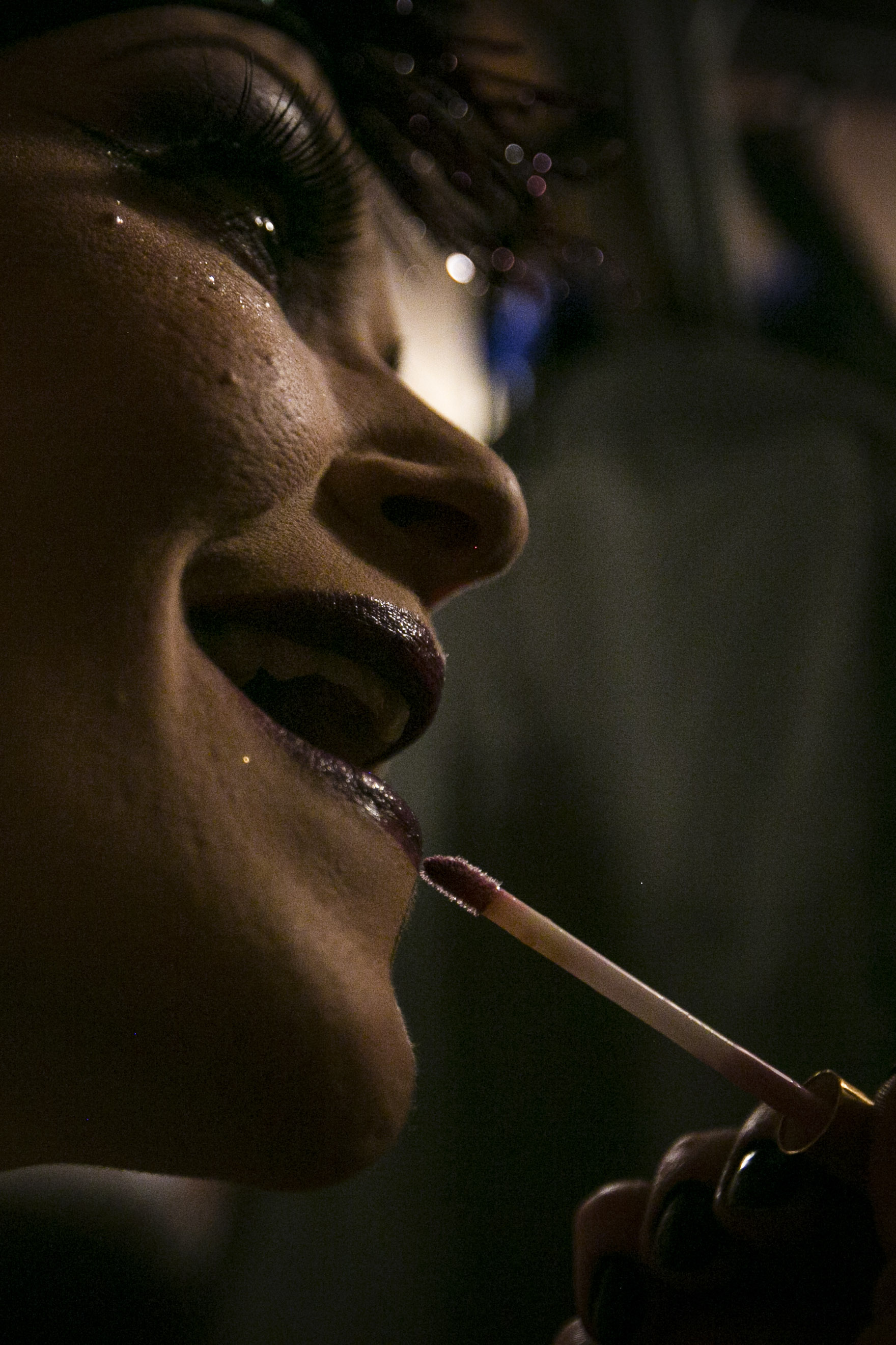  Jamie Prang lines her lips with a purple mat lipstick before the start of a burlesque show, Feb. 27, at Mark's III, in downtown Muncie, IN. Originally from Florida, Jamie came to Muncie and immersed herself into color guard and theater learning the 