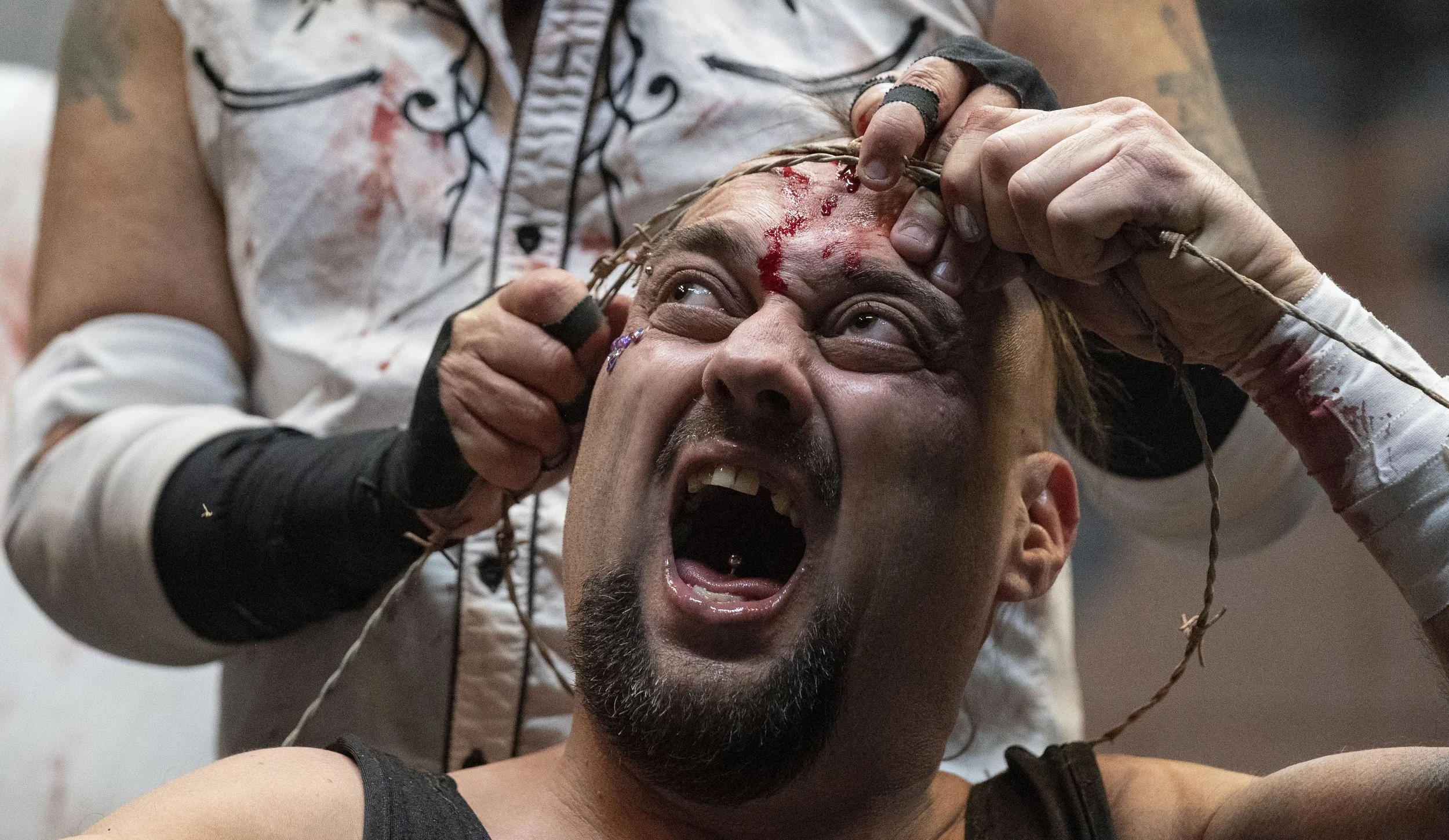  Pogo, wrestler with WCWO Wrestling, yells in pain as barbed wire is pressed into his forehead Friday, Feb. 27, 2022, at the WCWO Wrestling School on Kentucky Avenue, in Indianapolis. 