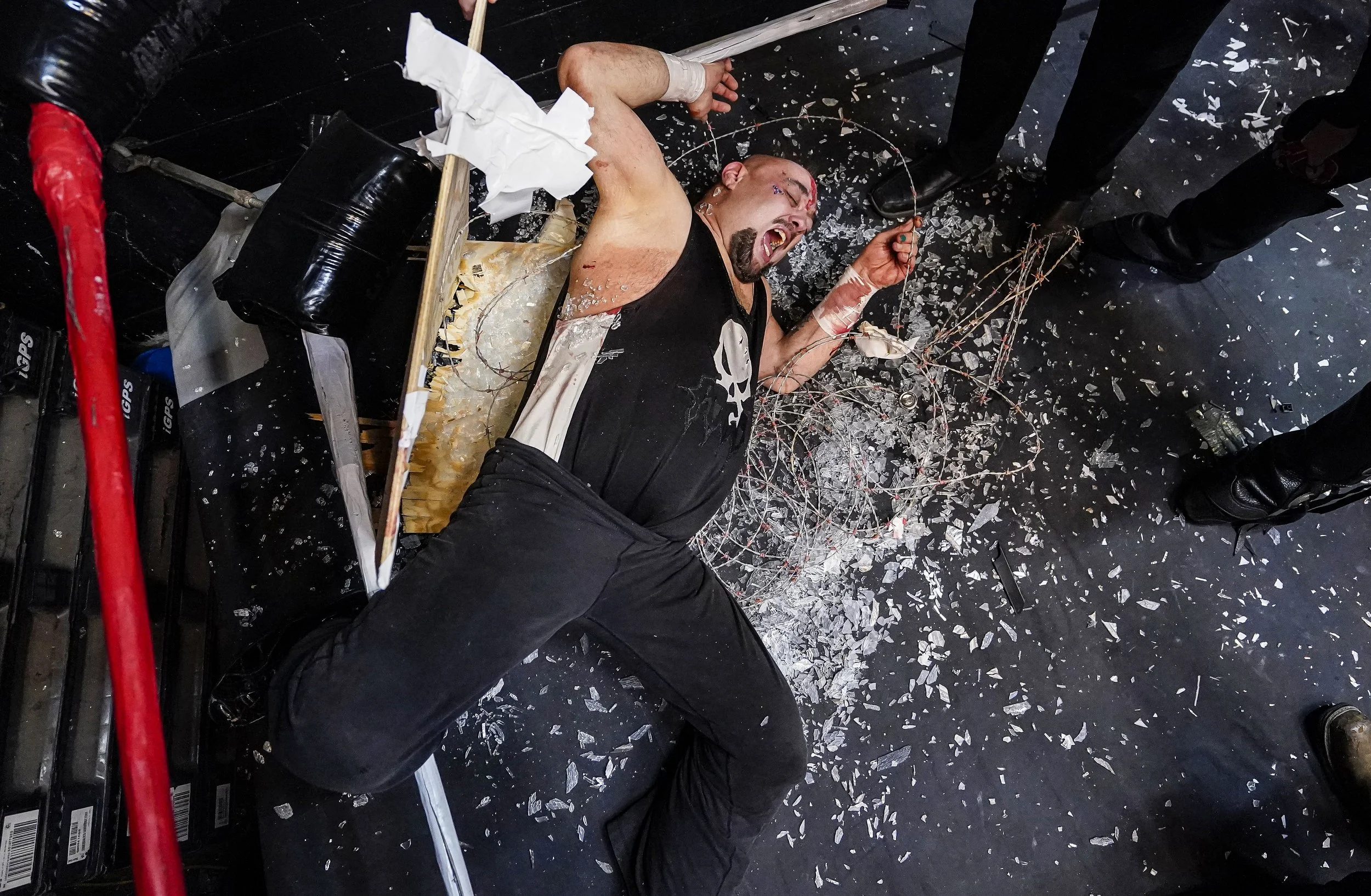  Pogo lays in broken glass and barb wire during a death match on Friday, Feb. 27, 2022 at the WCWO Wrestling School on Kentucky Avenue, in Indianapolis. 