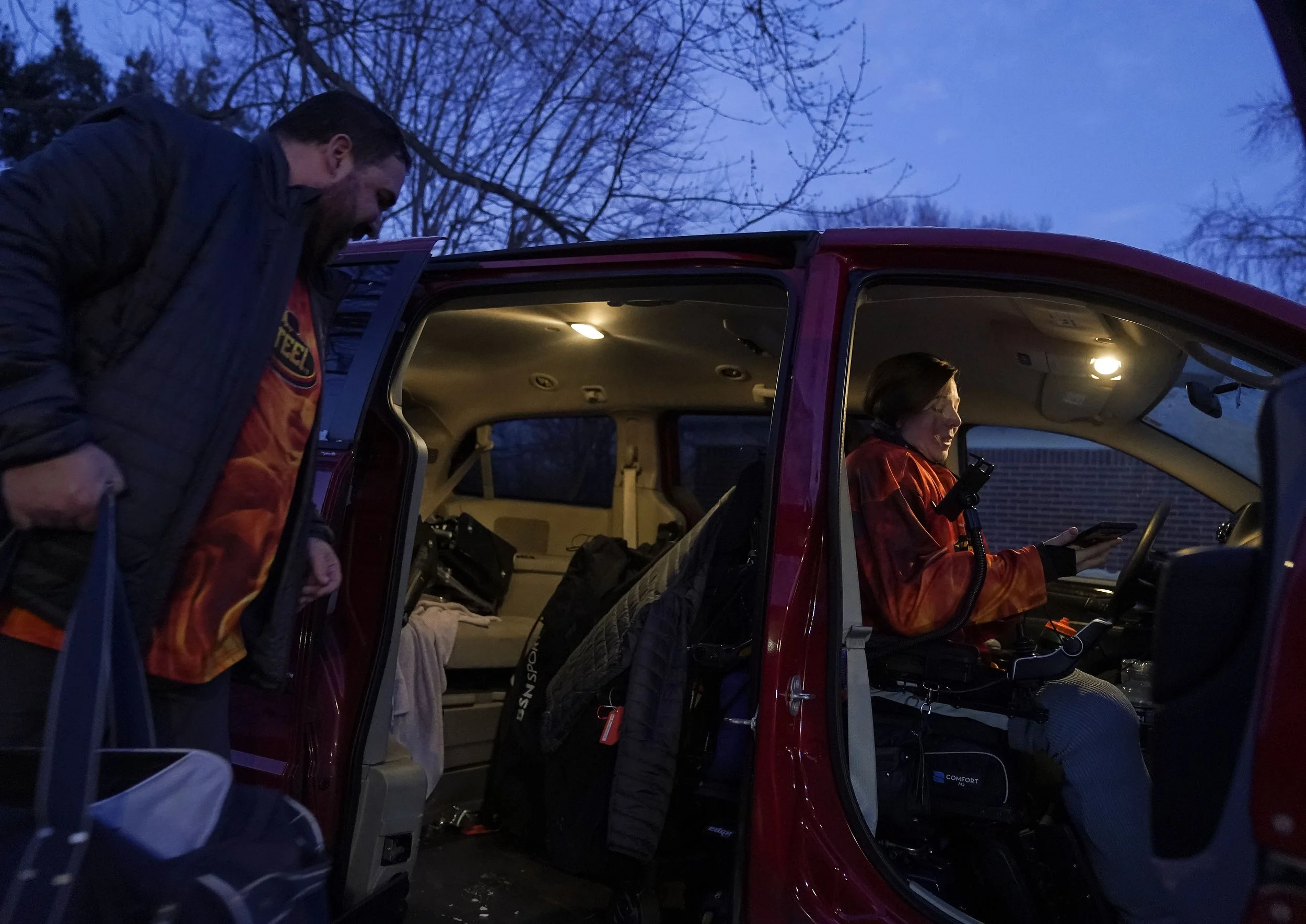  Marie Harman sits in their van as her husband packs it with hockey for sled hockey practice January 28, 2022, at her home in Indianapolis. 