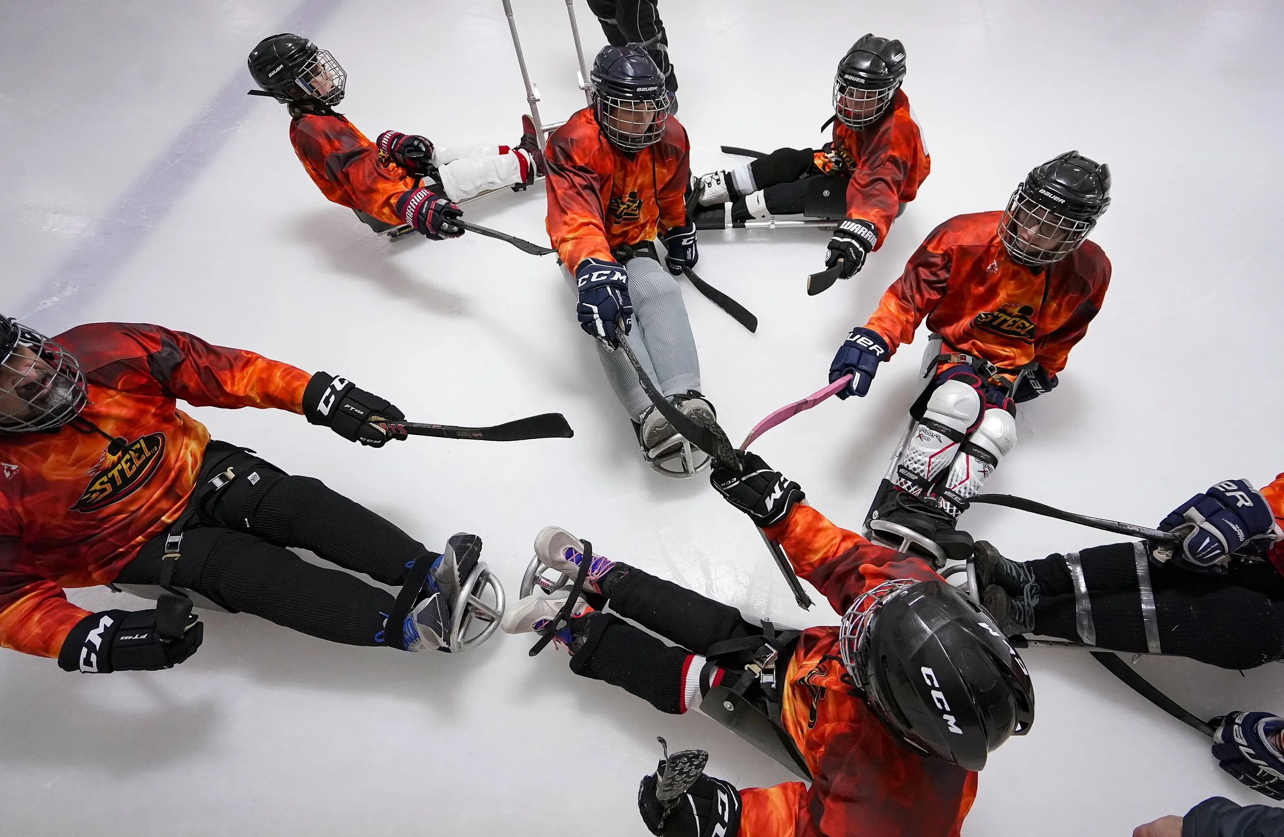  Indy Steel sled hockey players gather together to cheer during a sled hockey scrimmage on January 22, 2022, at Perry Park in Indianapolis. 