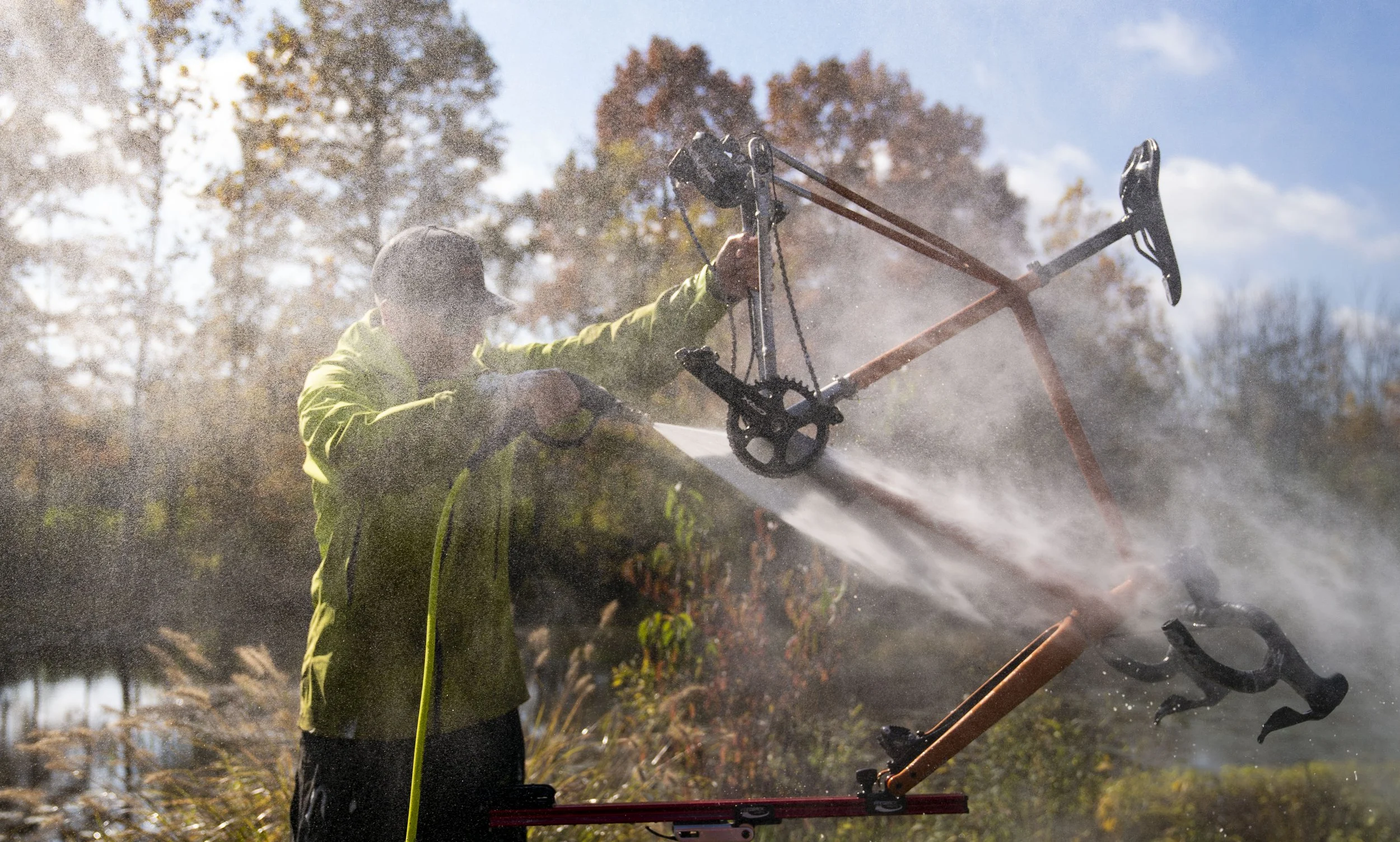  A cyclist sprays off bikes during the Major Taylor Cyclocross cup race Sunday, Oct. 31, 2021 at the Indy Cycloplex on Cold Spring Road, in Indianapolis. 