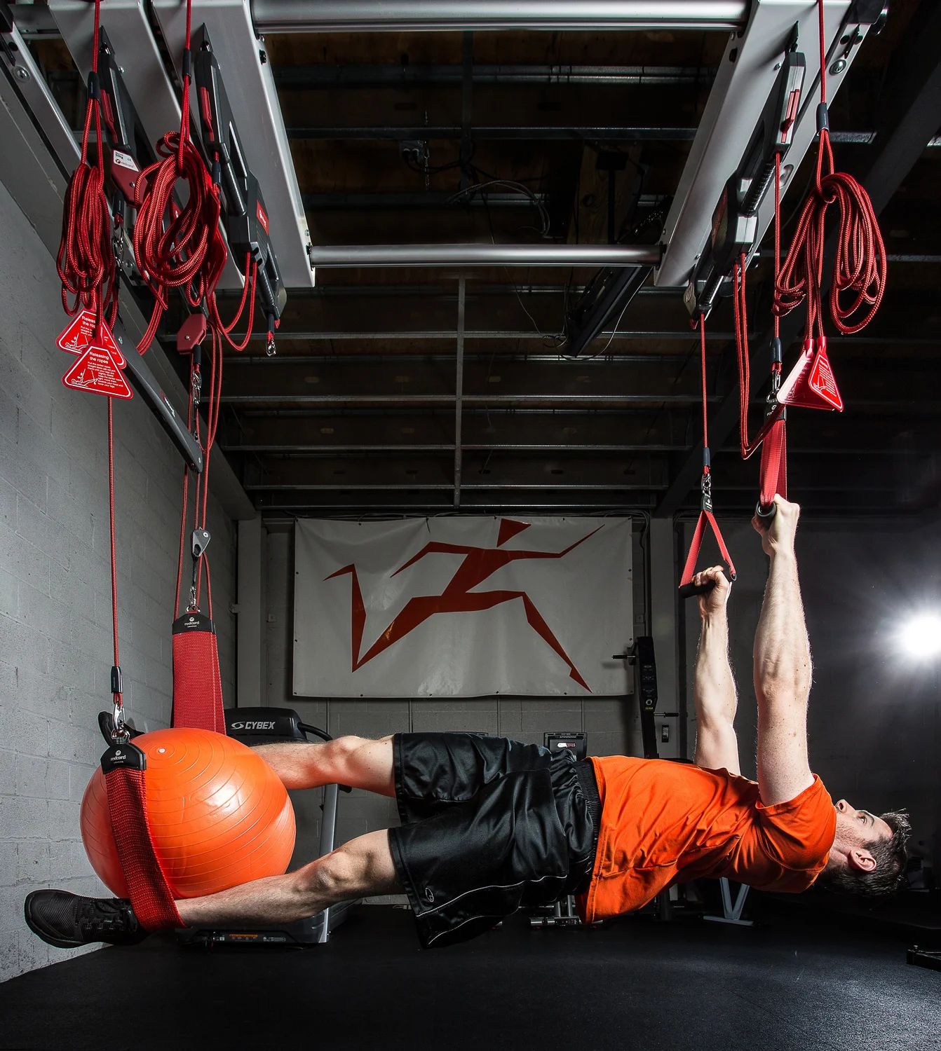 Athlete working on rotary stability on Redcord system