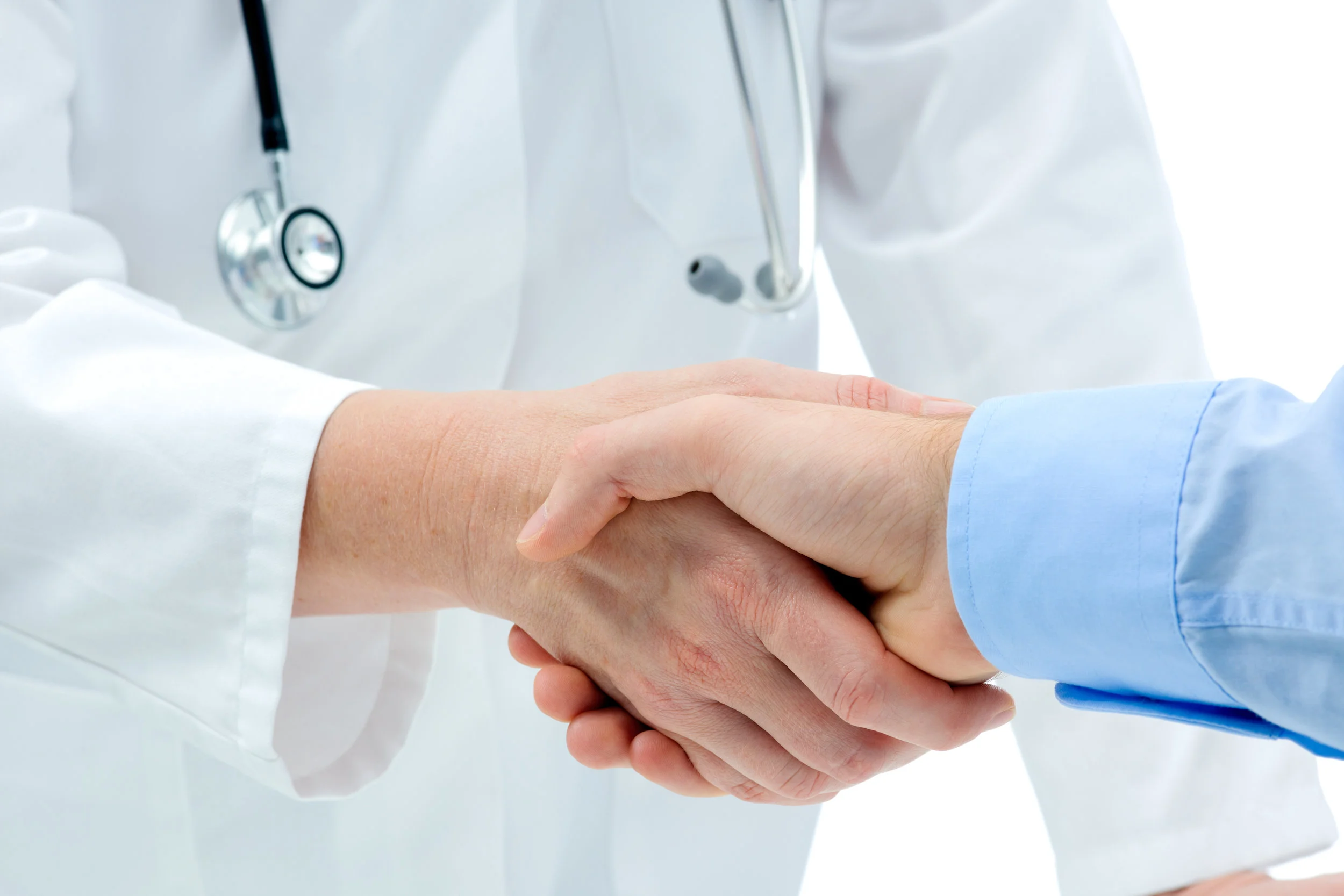Medical physician in wihte lab coat with stethoscope shaking the hand of a female patient