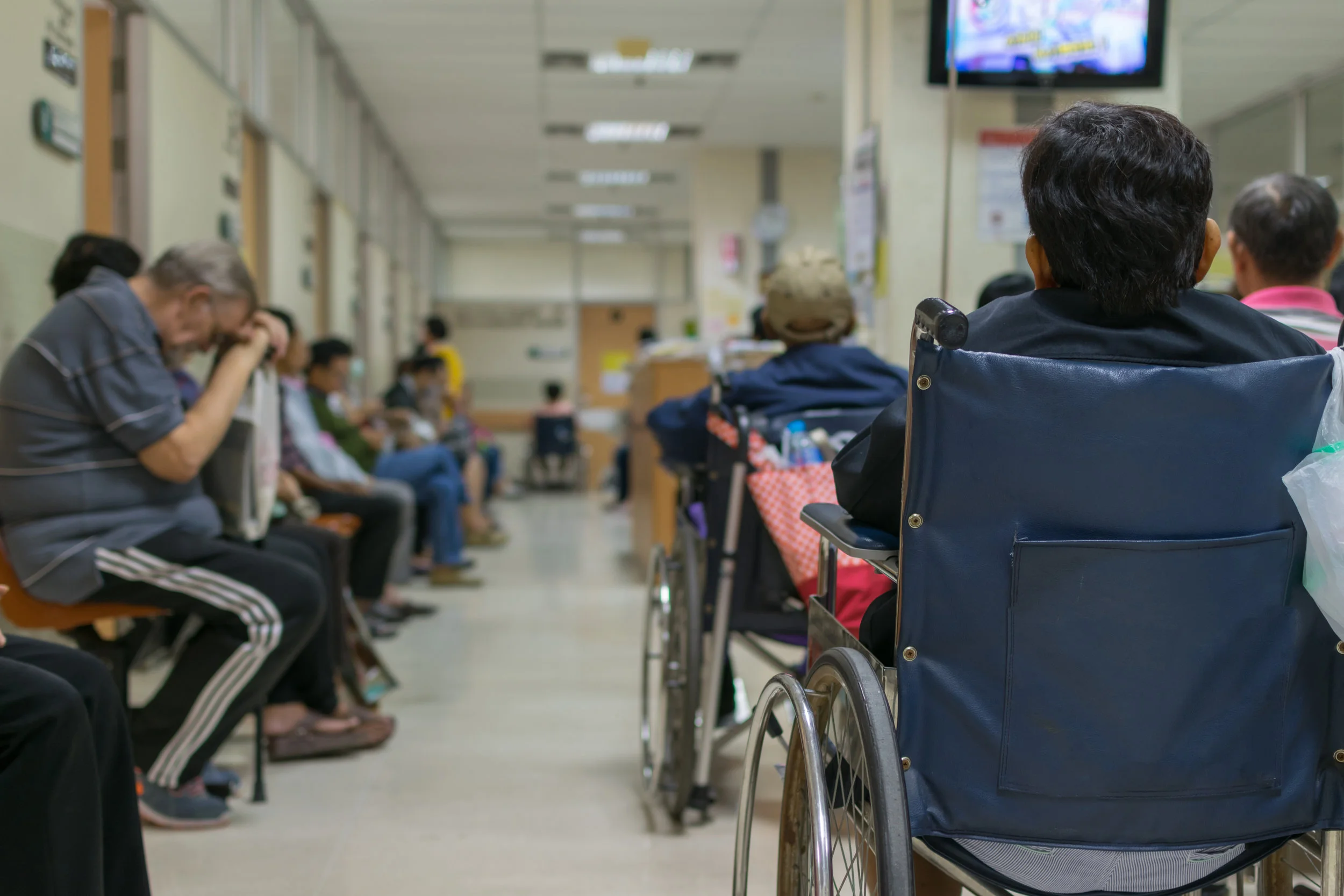 A room packed with tired patients waiting to see their primary care provider