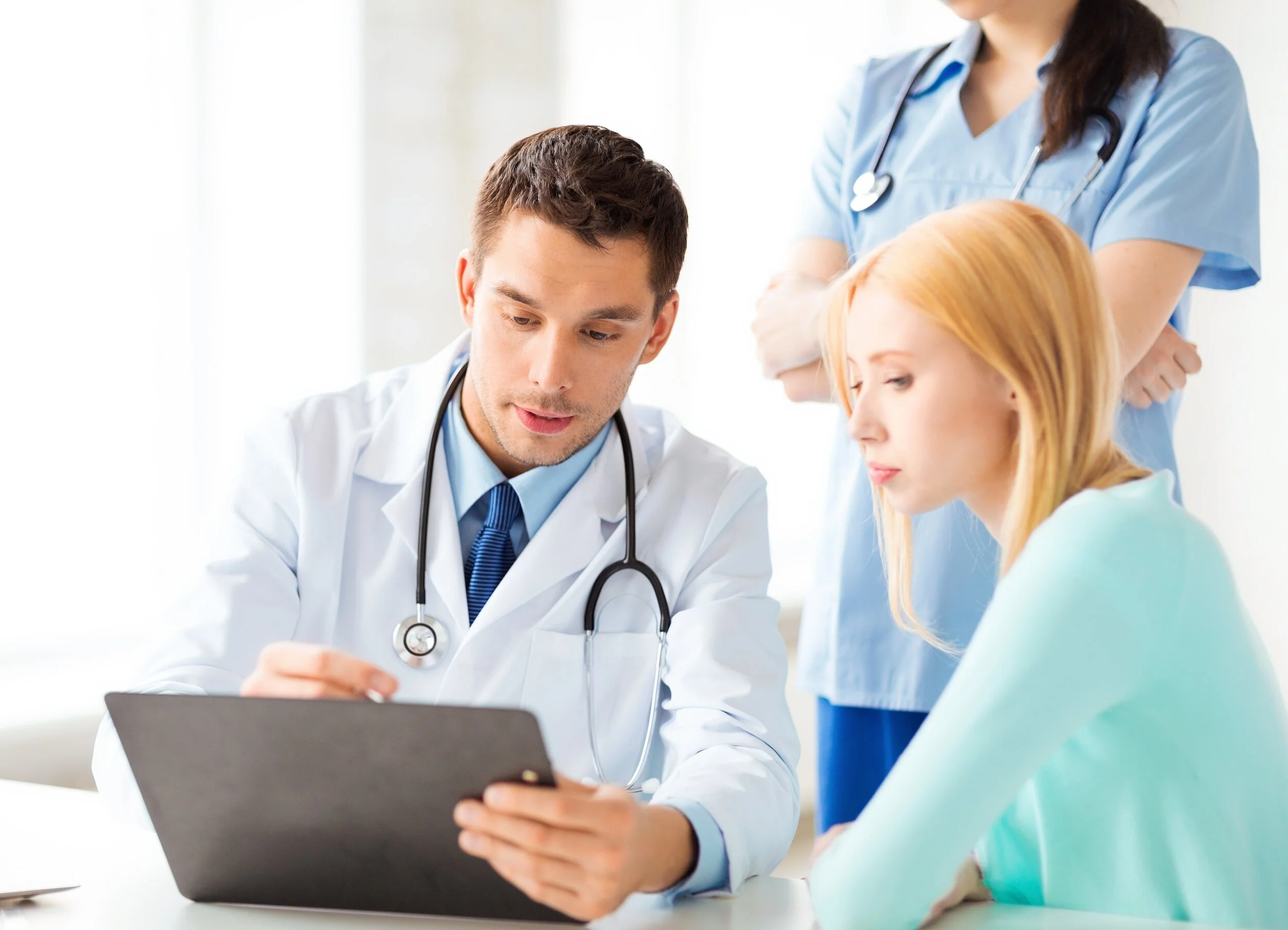 Male physician talking with patient at an in-person visit