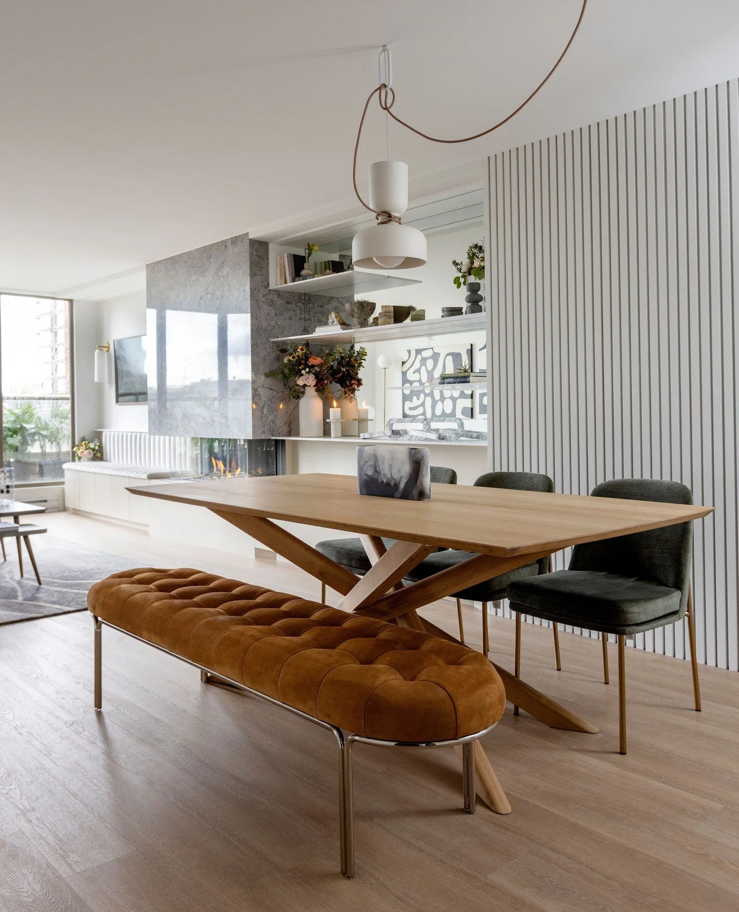 In this client's home, we faced the challenge of creating a defined dining space within a larger open floor plan. The goal was to maintain a seamless inviting flow to the room while also differentiating the dining area from the joining living space.