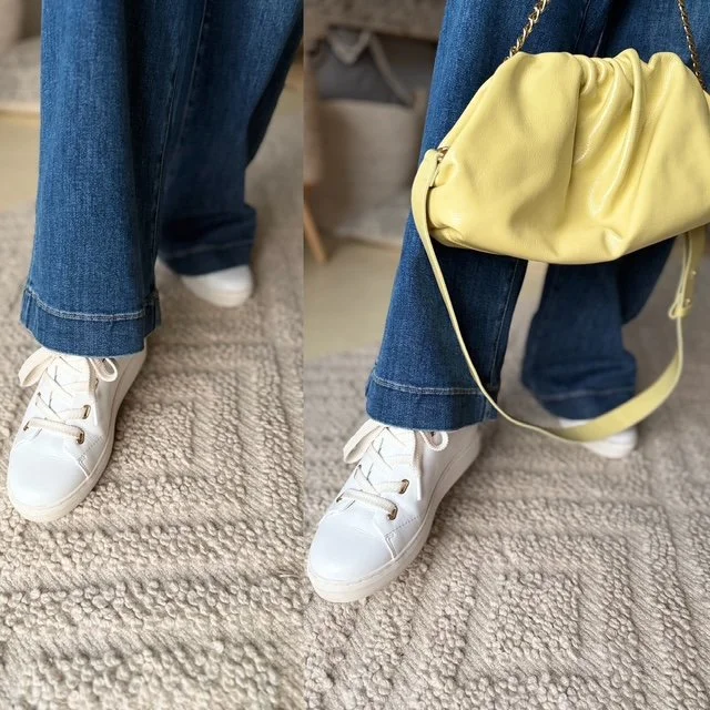 womens legs knees down jeans white sneakers yellow hangbag