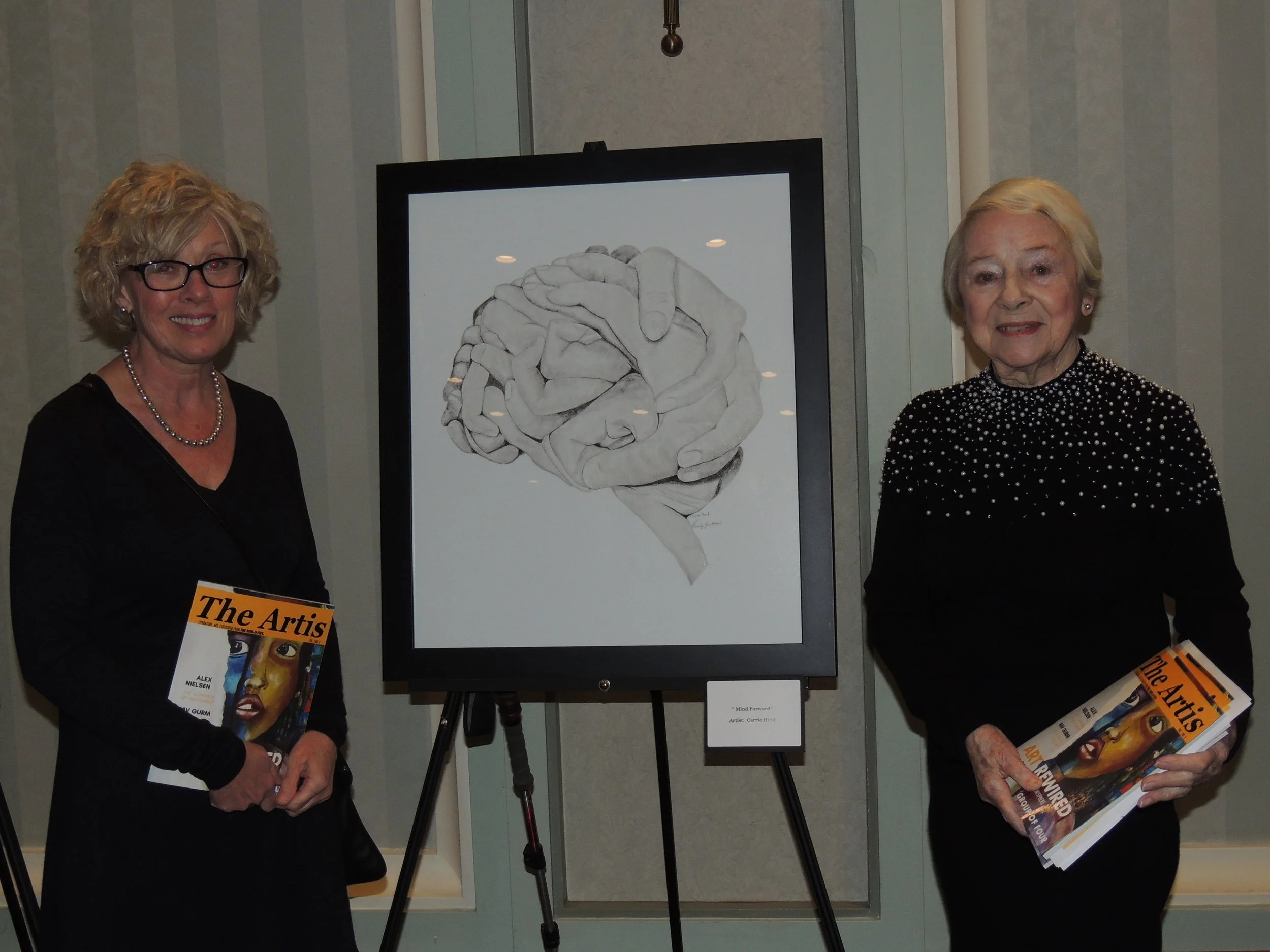 Artist Carrie Hind from The 905's Group of Four stands in front of one of her masterpieces with Doloris. Photo by Mira Louis.