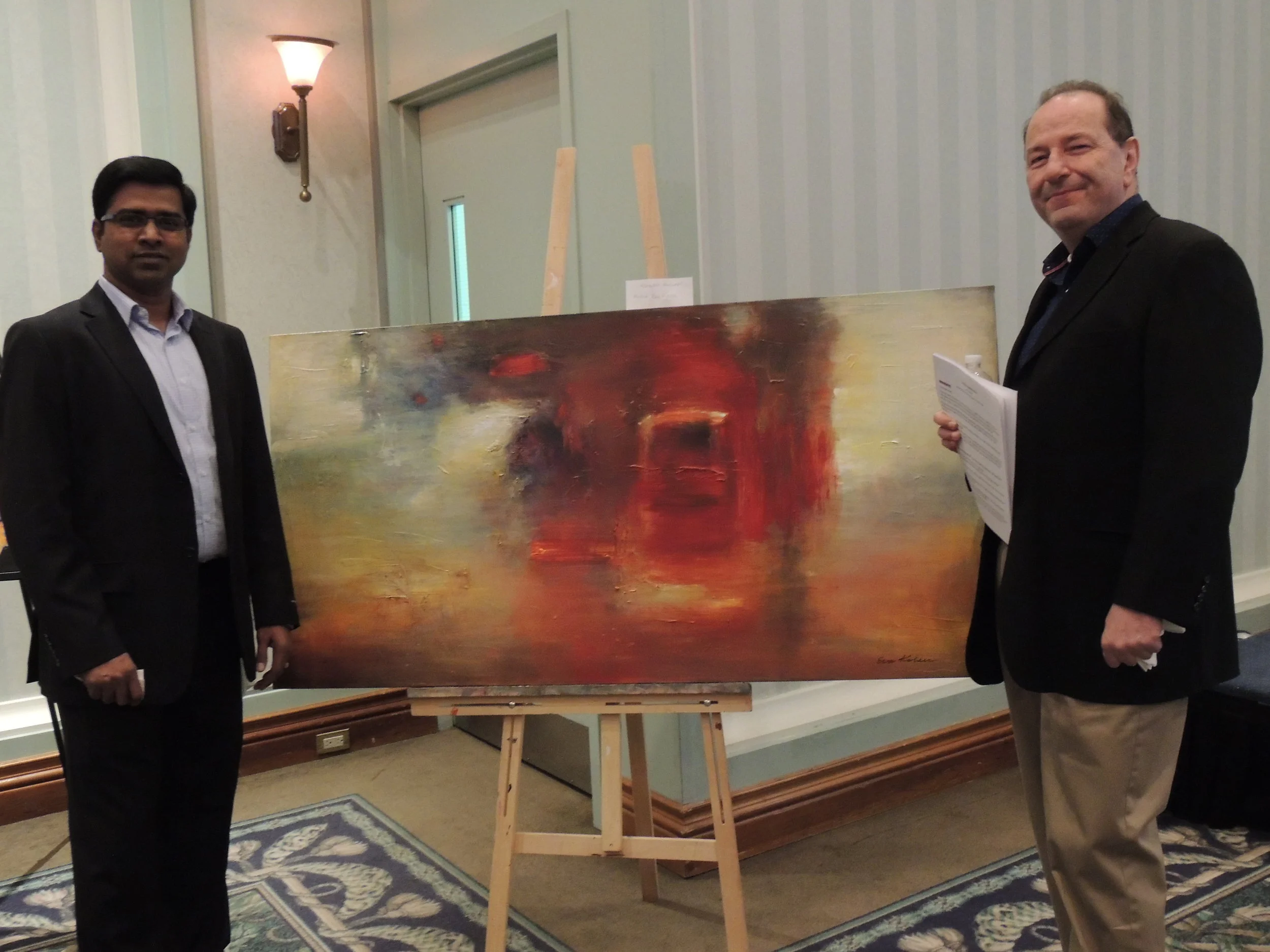 Keynote Speaker of the evening and Artis Op-Ed contributor Frank Veri (right) admiring Eva Kolacz's art with friend Sundar. Photo by Mira Louis.