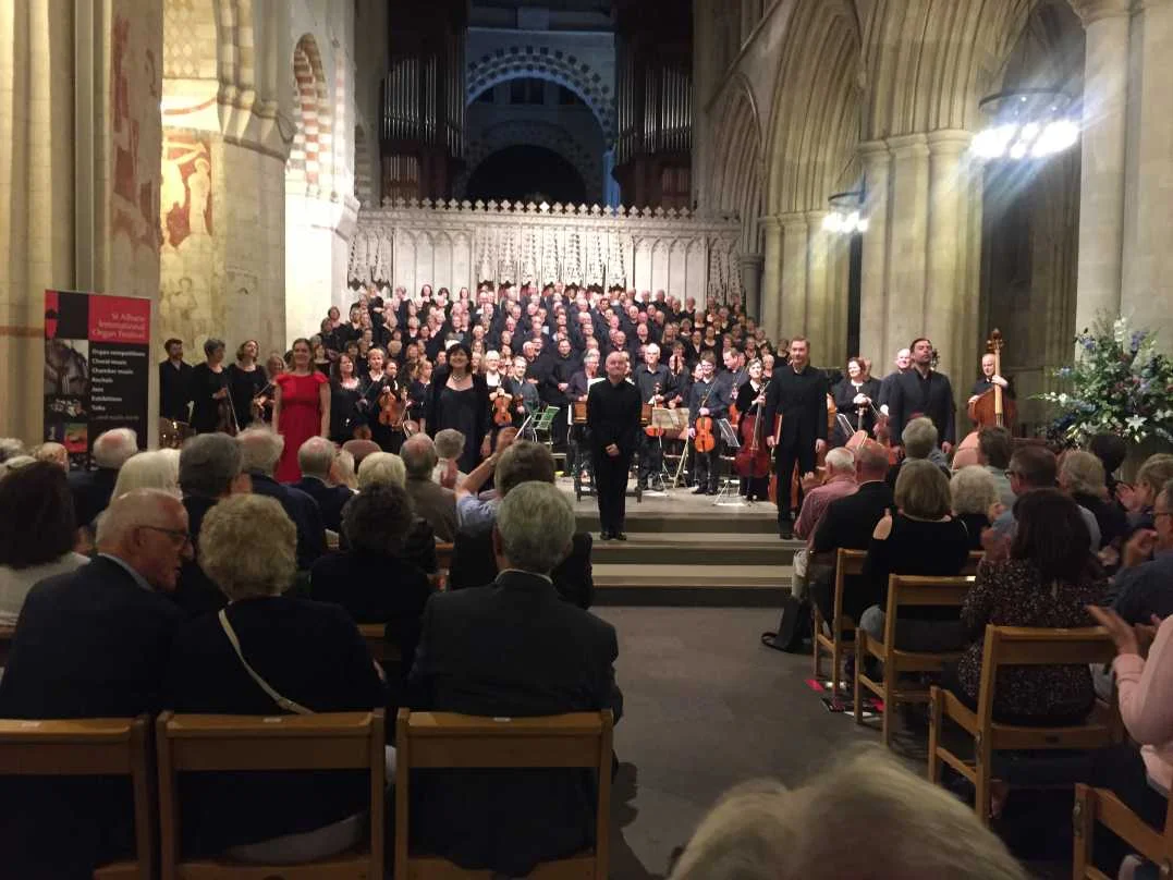 Conductor, soloists, orchestra and choir acknowledge raturous applause.