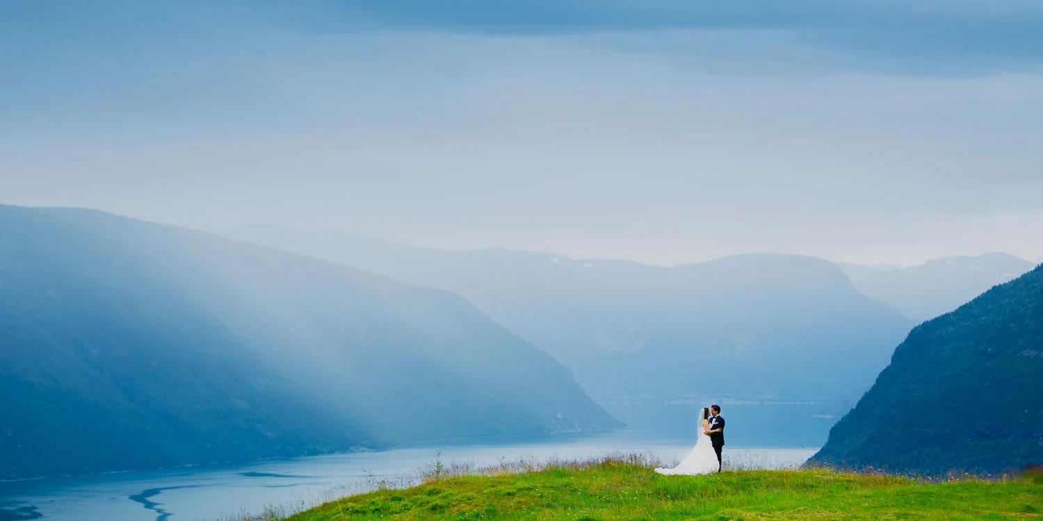Foto: Jan Ivar Vik . Overskyet vær og regnbyger kan skape fantastisk stemning i bryllupsbildene deres. Her fra et bryllup i Sogn .