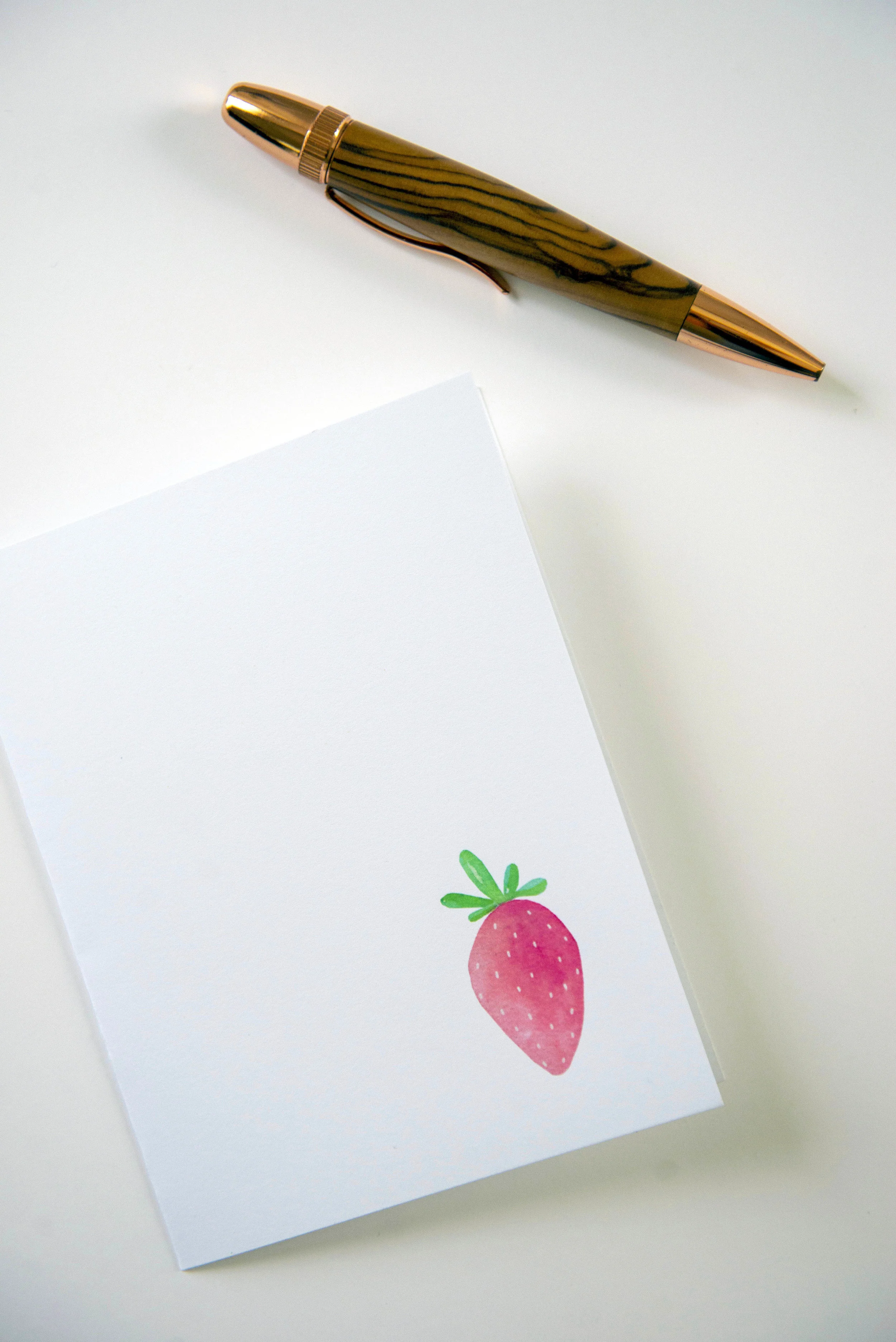 Printable watercolor greeting card featuring a sweet pink strawberry in the lower right corner. Download once and print again and again!  Prints (2) cards per 8.5x11 inch paper. 