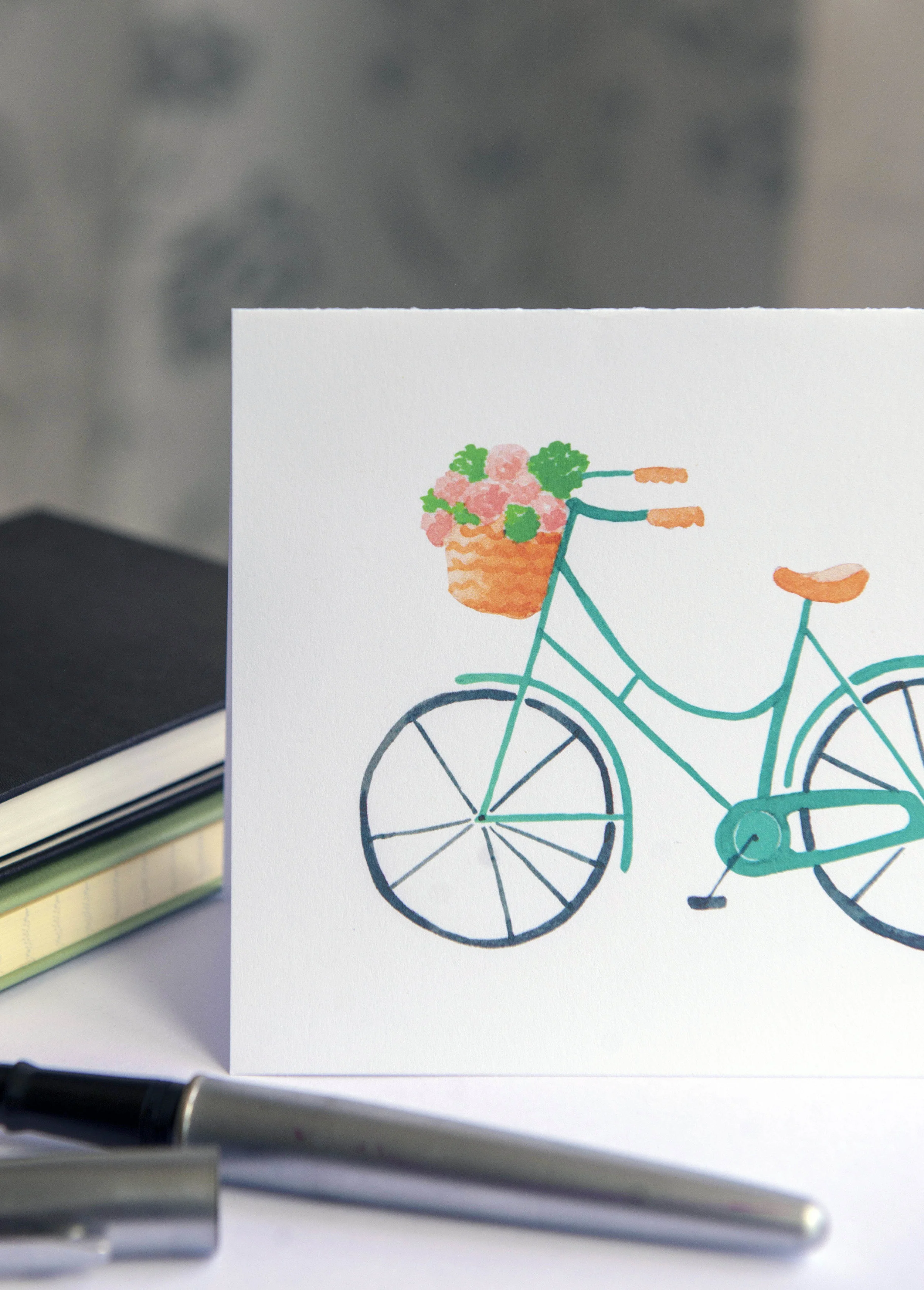 Printable watercolor greeting card featuring a vintage blue bicycle with a flower basket. Download once and print again and again!  Prints (2) cards per 8.5x11 inch paper. 